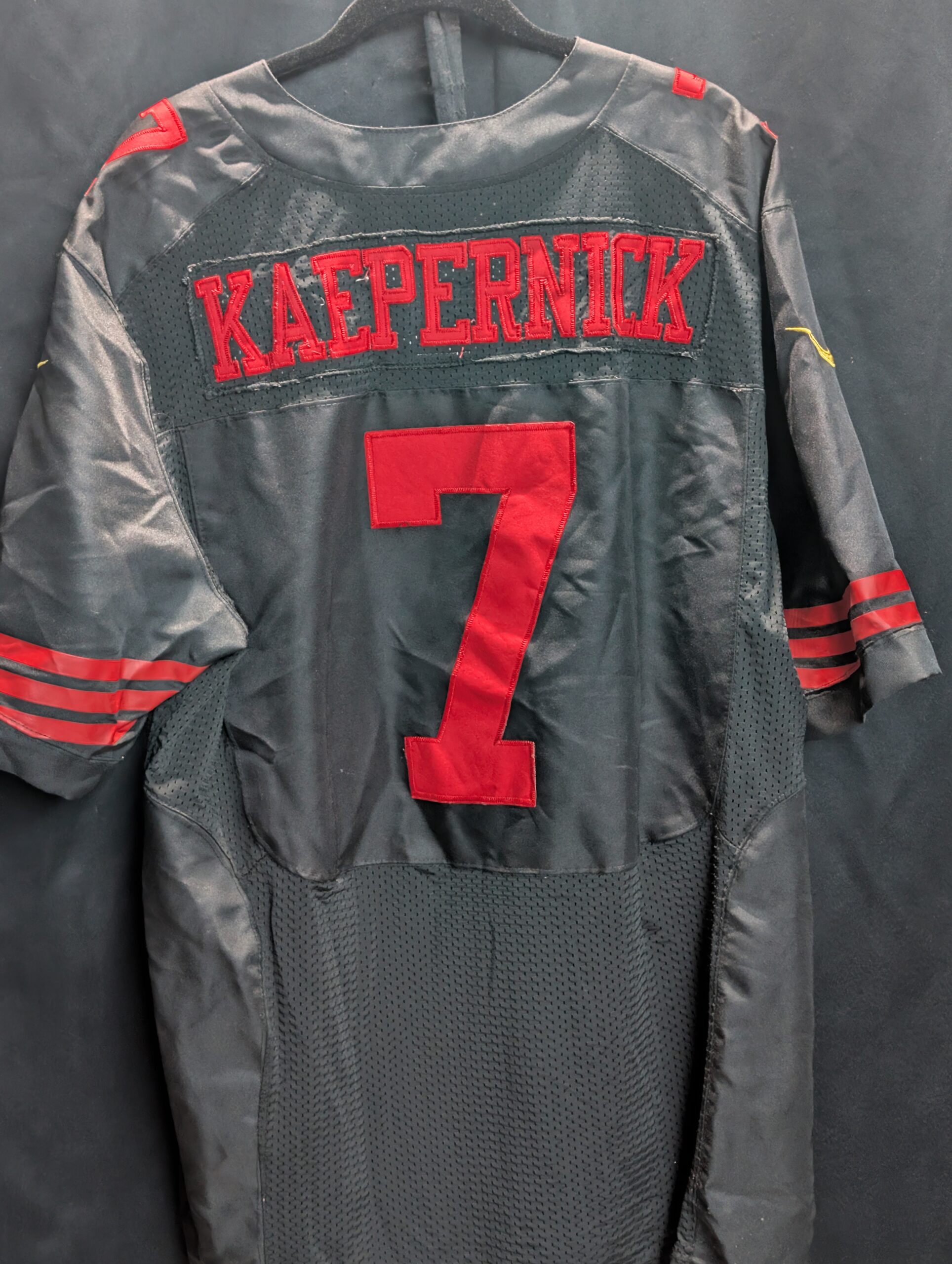 Authentic used black Nike San Francisco forty niners Colin Kaepernick football jersey in size forty eight displaying classic red stitched numbers perfectly captured for premium sports apparel collectors.