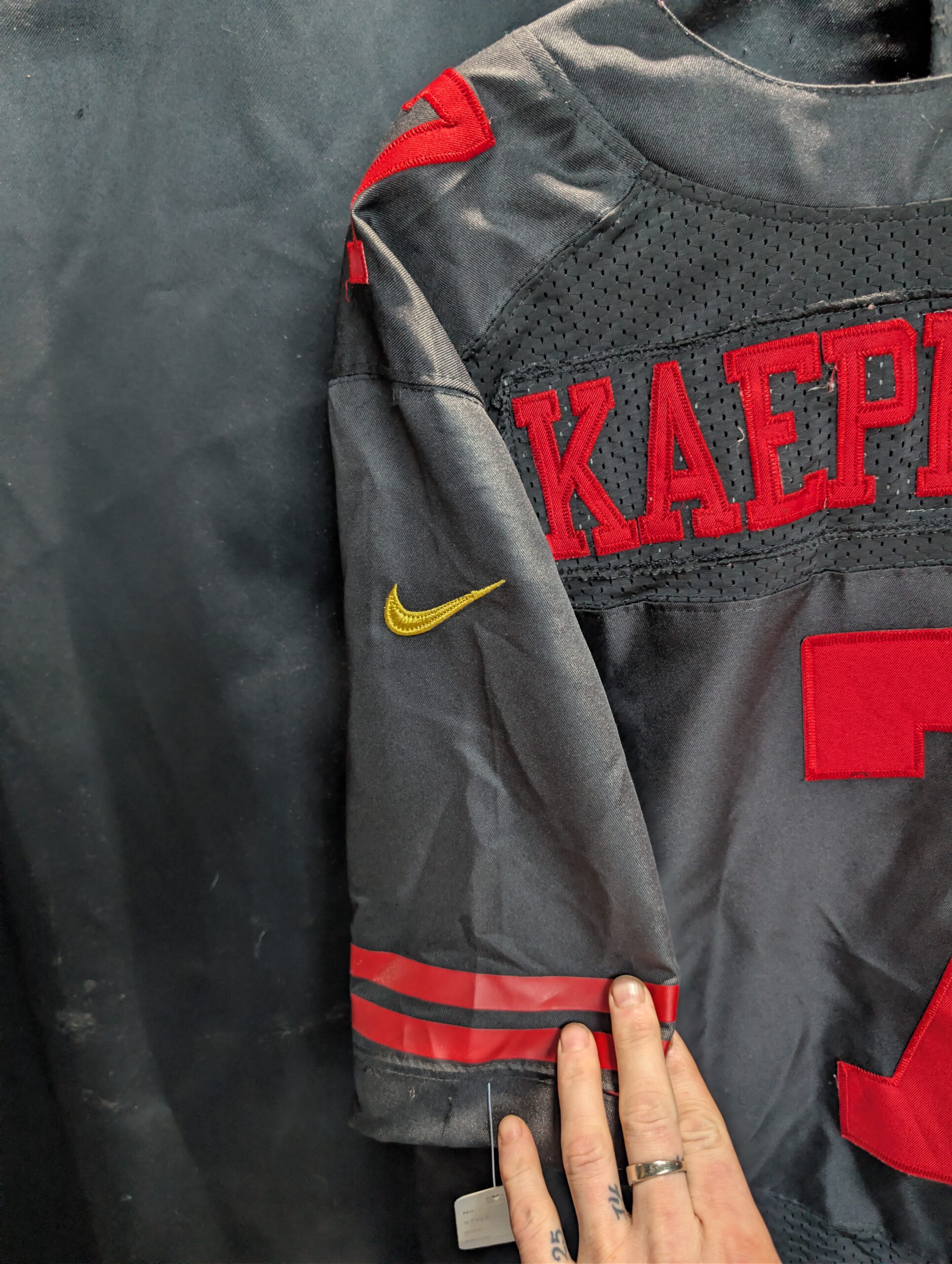 Authentic used black Nike San Francisco forty niners Colin Kaepernick football jersey in size forty eight displaying classic red stitched numbers perfectly captured for premium sports apparel collectors.