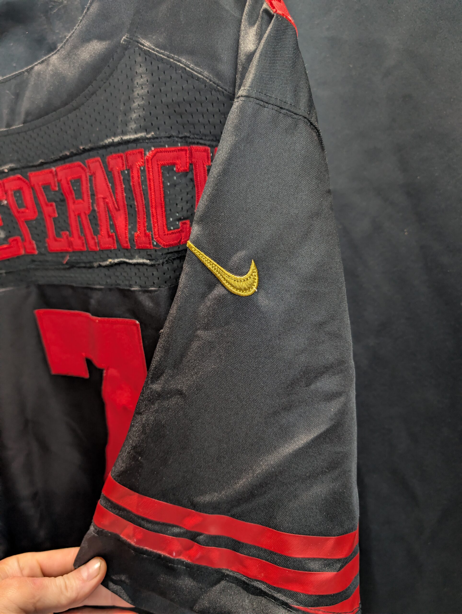 Authentic used black Nike San Francisco forty niners Colin Kaepernick football jersey in size forty eight displaying classic red stitched numbers perfectly captured for premium sports apparel collectors.
