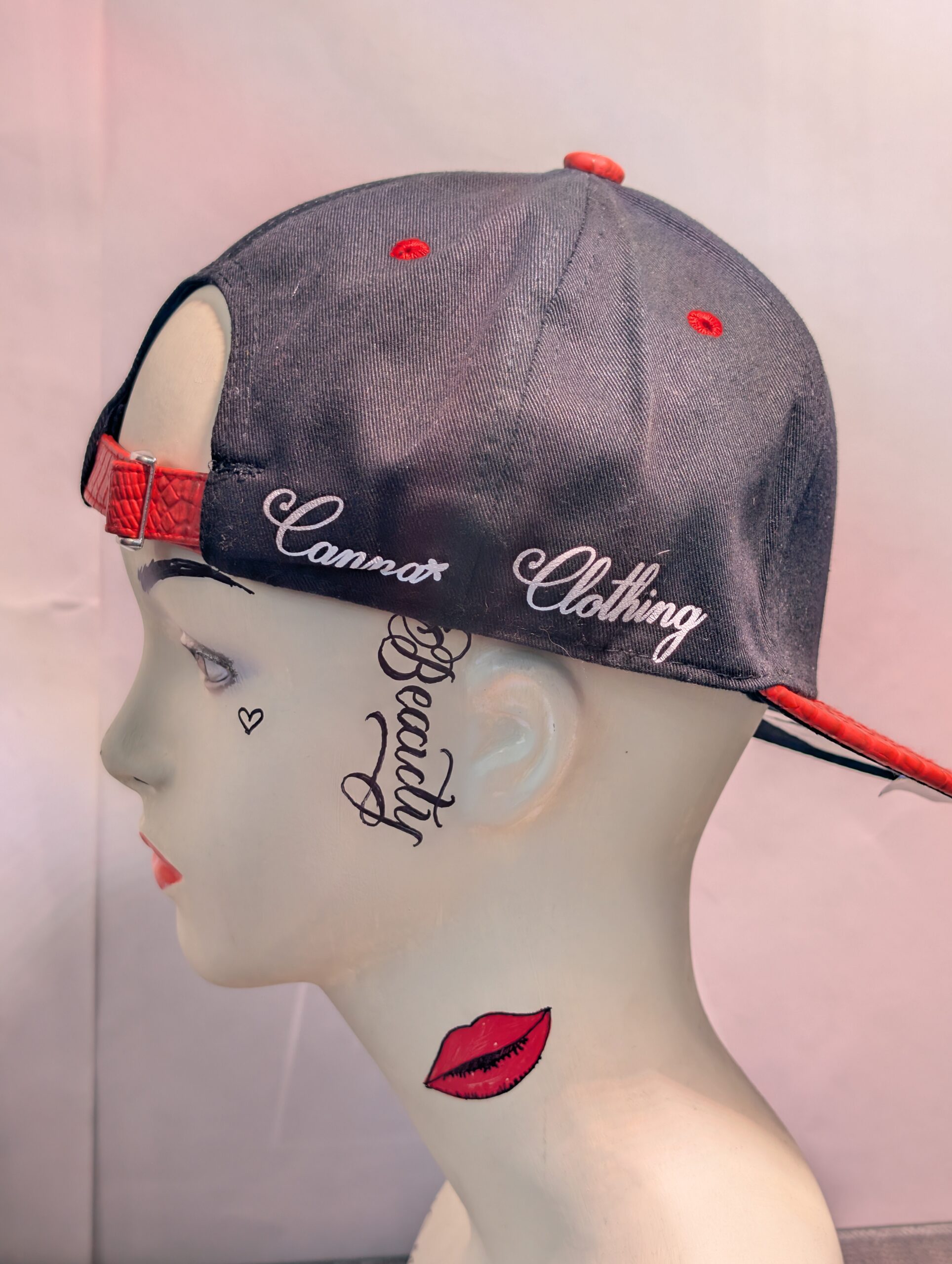 Black structured streetwear snapback hat featuring embroidered cartoon mushroom graphic alongside bright green dripping slime logo and textured red crocodile faux leather flat bill edge for style.