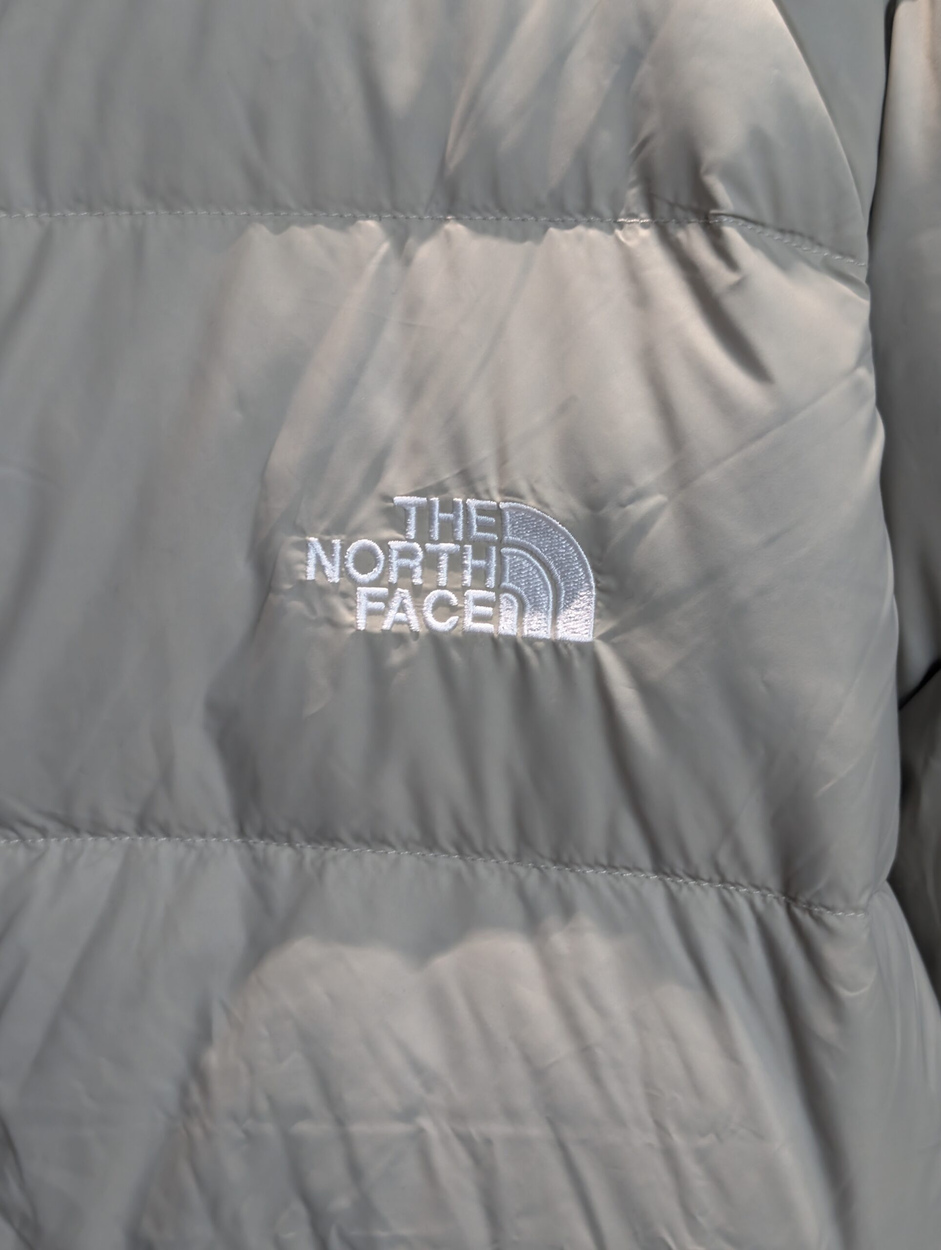 Front view of The North Face Mens Hydrenalite Hoodie in Clay Grey showing the recycled down puffy design and logo.
