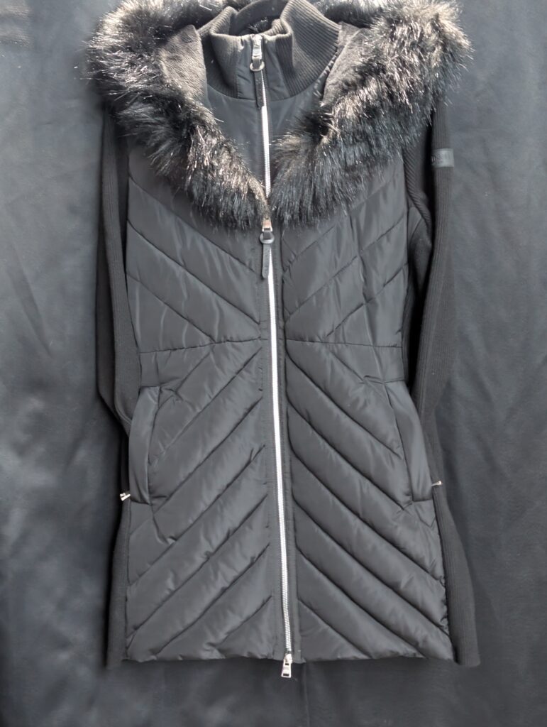 Close up of the inner tag for a Calvin Klein Performance black puffer jacket showing size large.