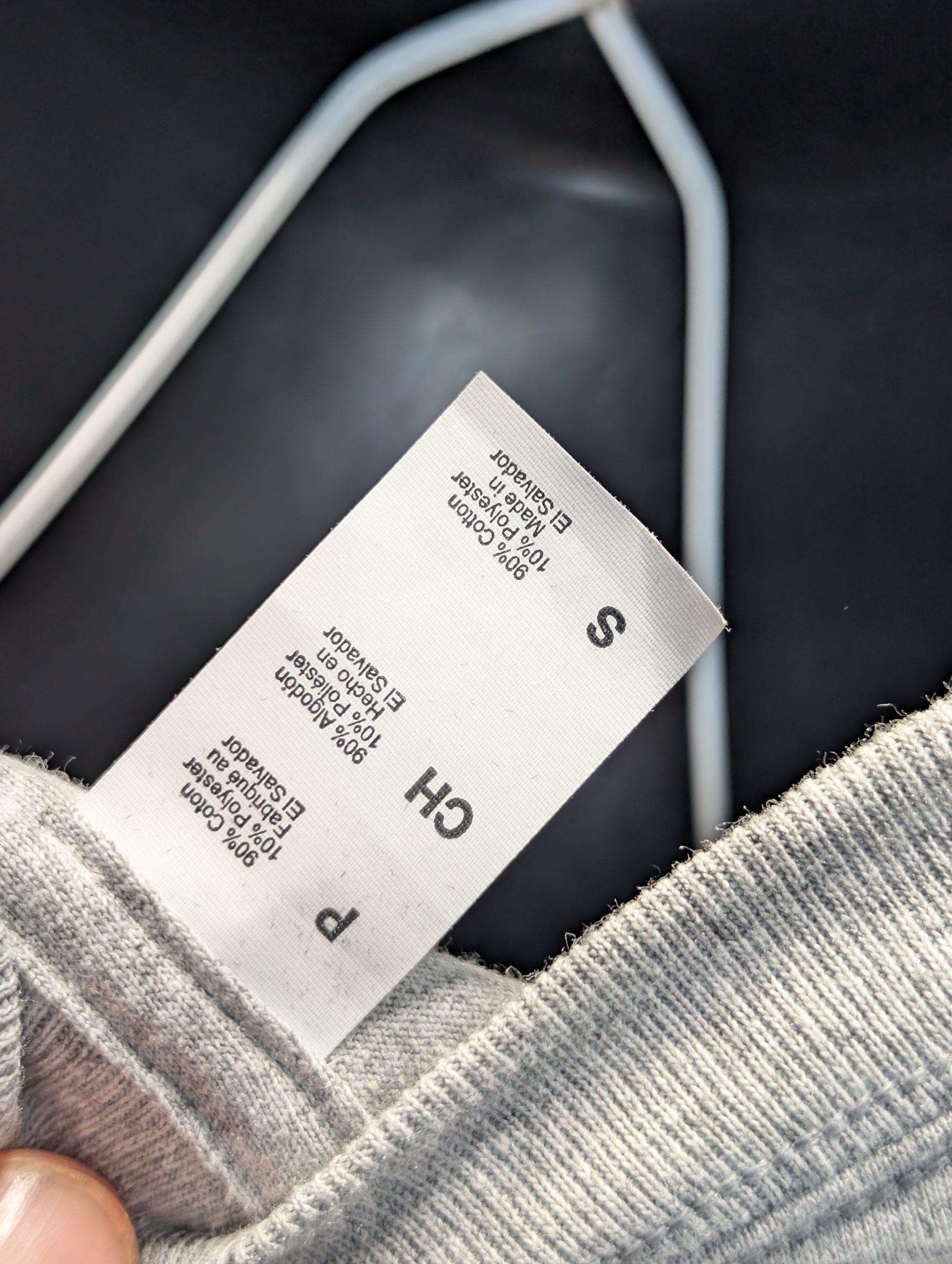 Grey shirt featuring blue yellow Sticky Canna logo Tag.