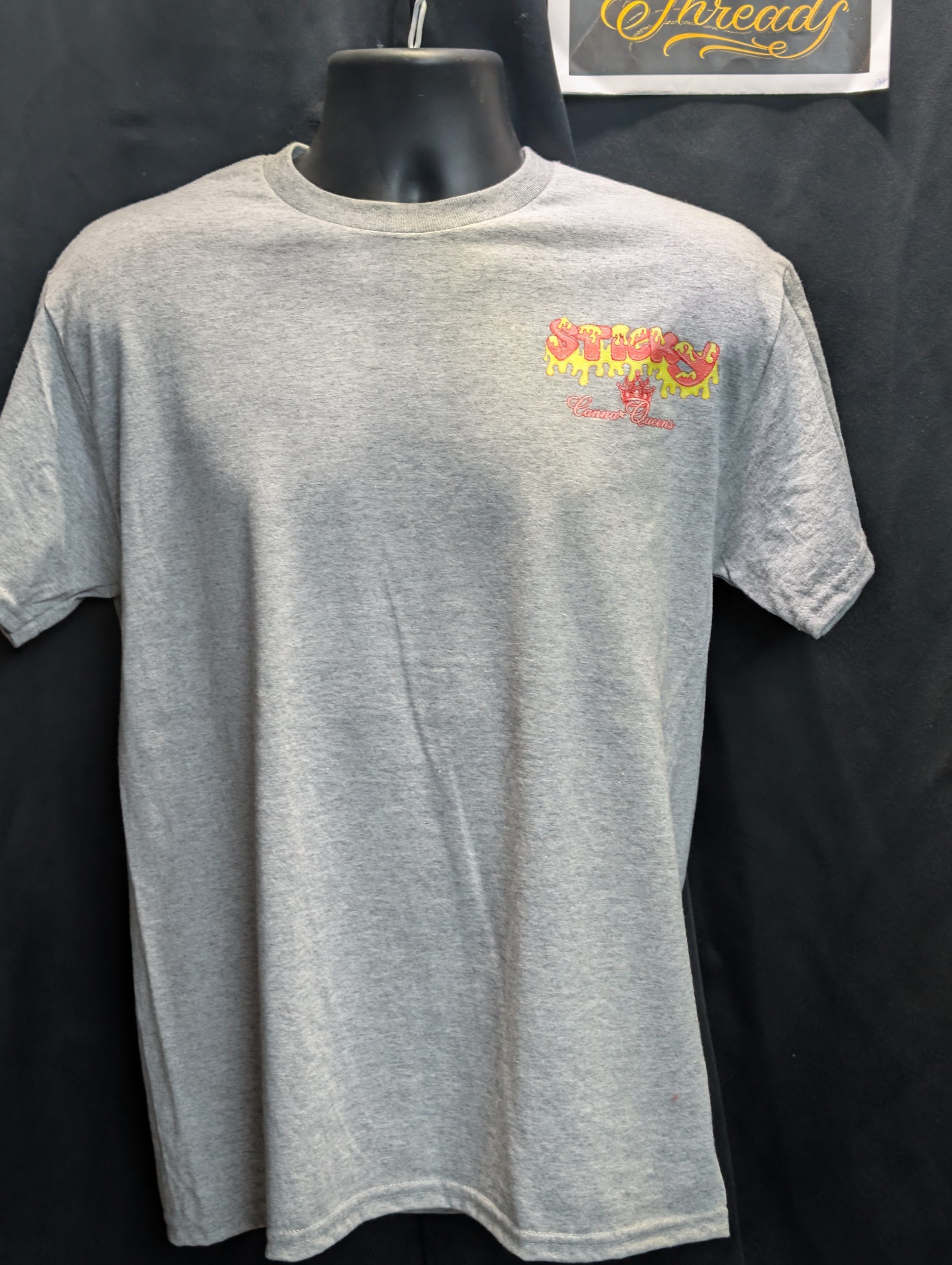 Grey shirt featuring pink yellow Sticky Queens logo.