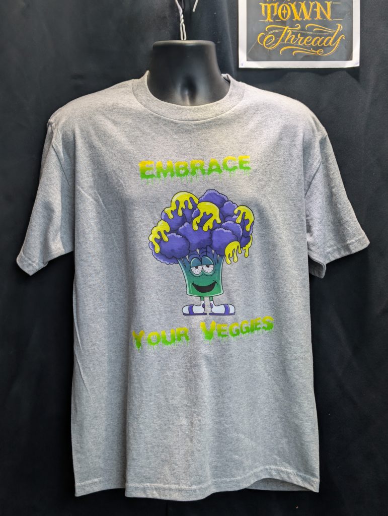 Grey shirt featuring embrace your veggies broccoli graphic.
