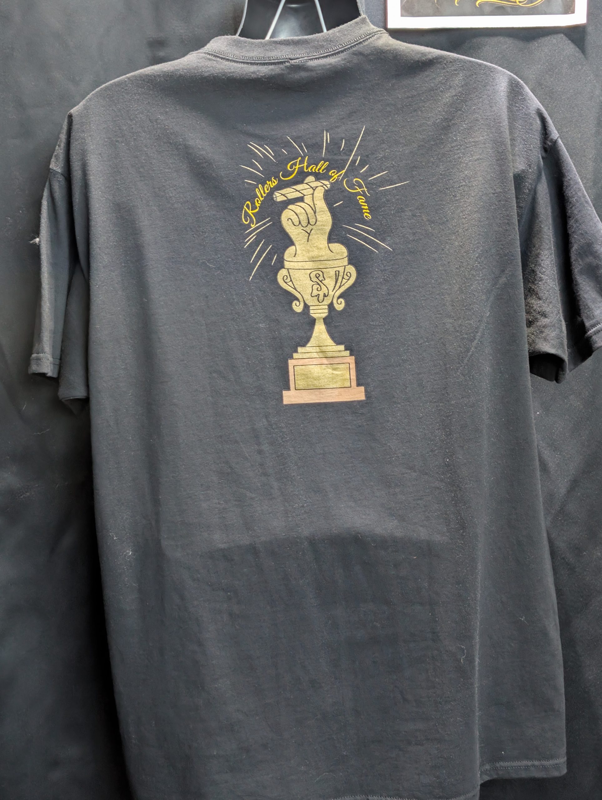 Black shirt featuring gold Rollers Hall of Fame.
