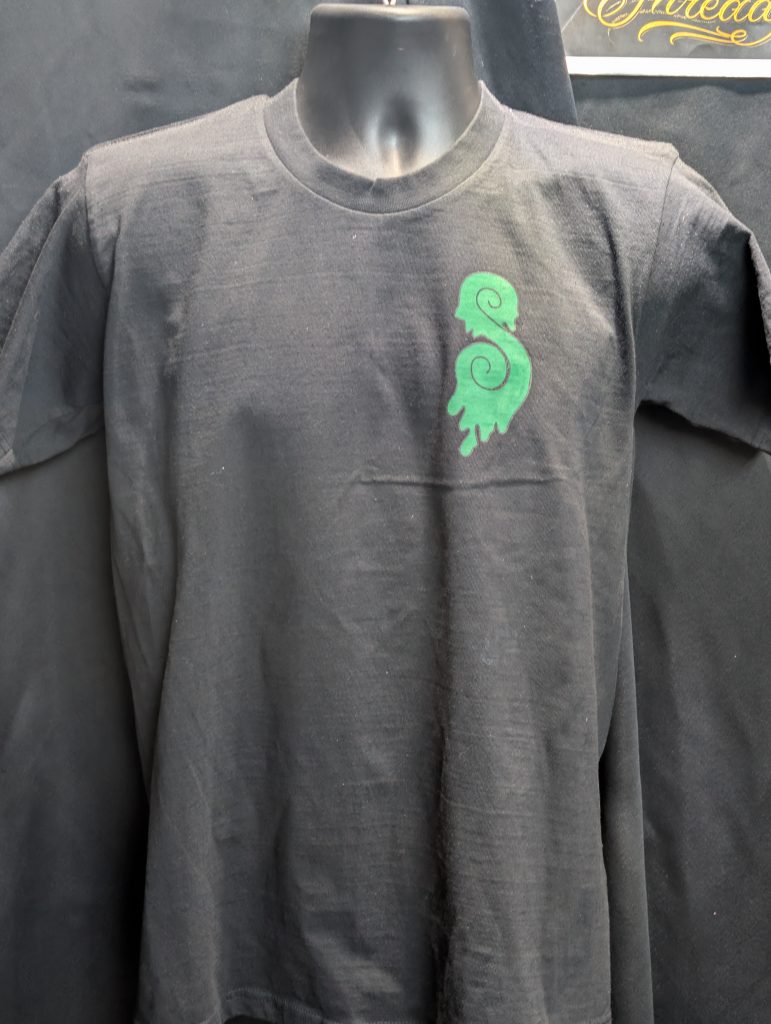 Black shirt featuring green Earthy Gas smoking globe.