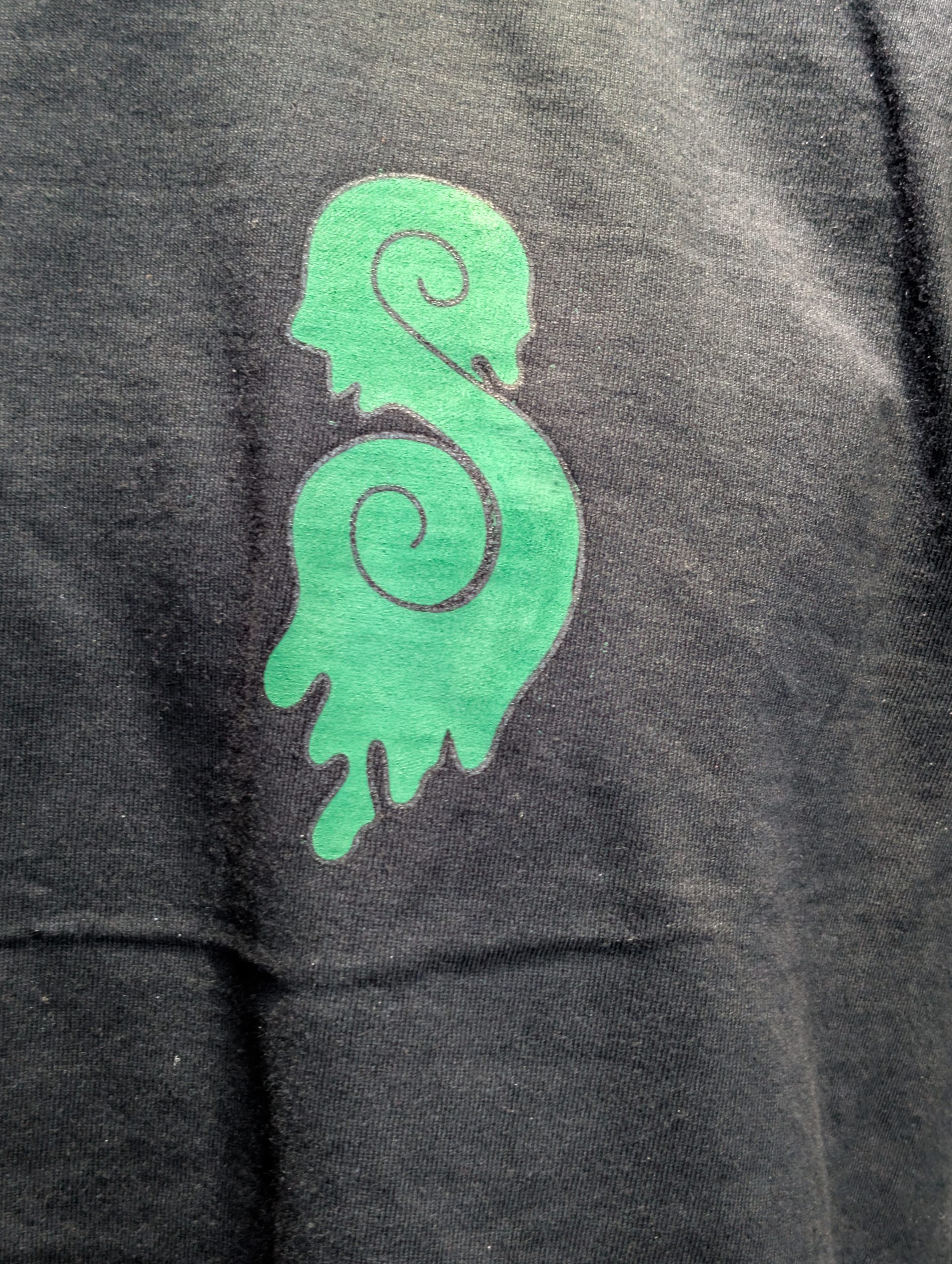 Black shirt featuring green Earthy Gas smoking globe.