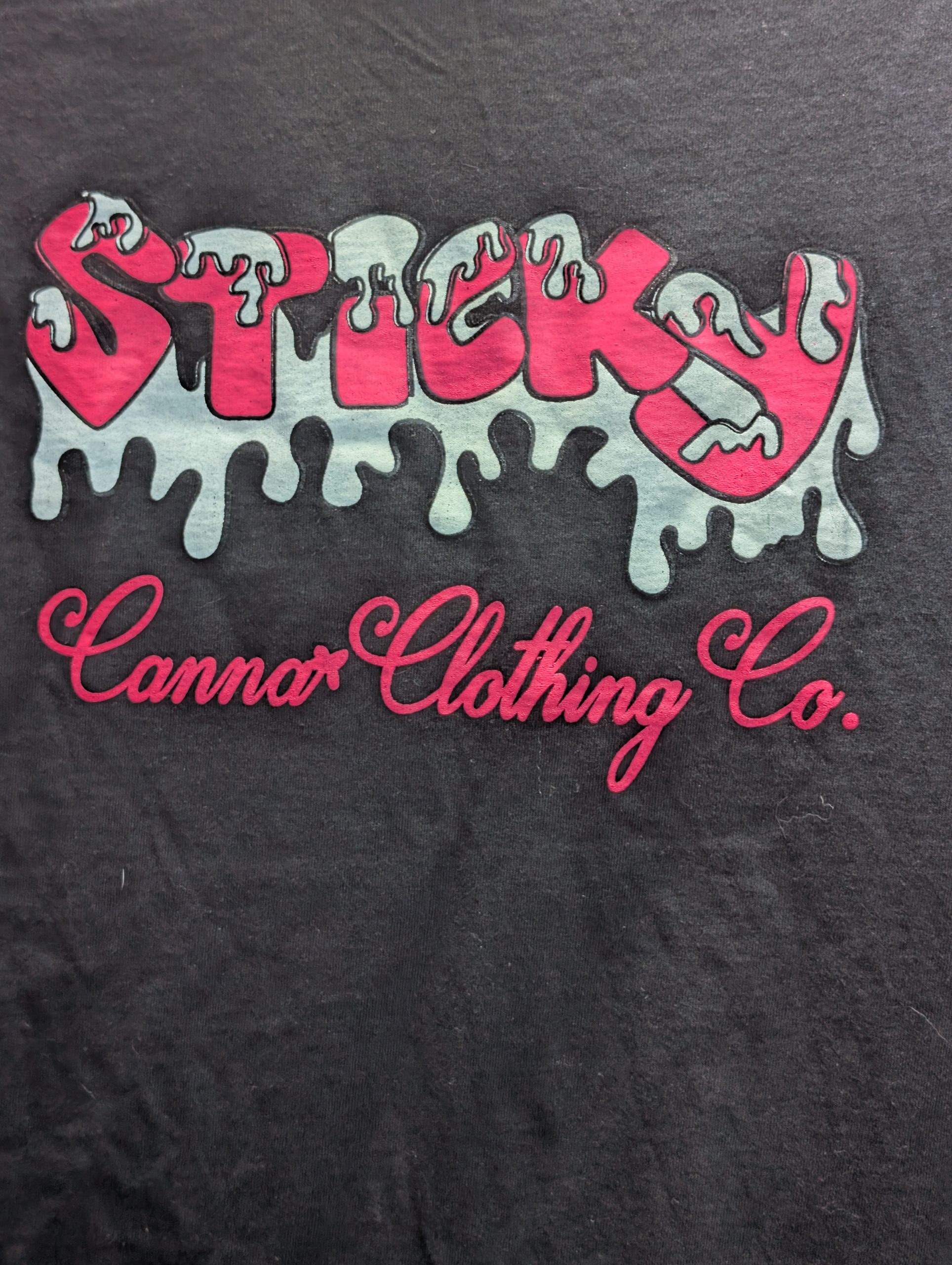 Black shirt featuring hot pink Sticky Canna logo.