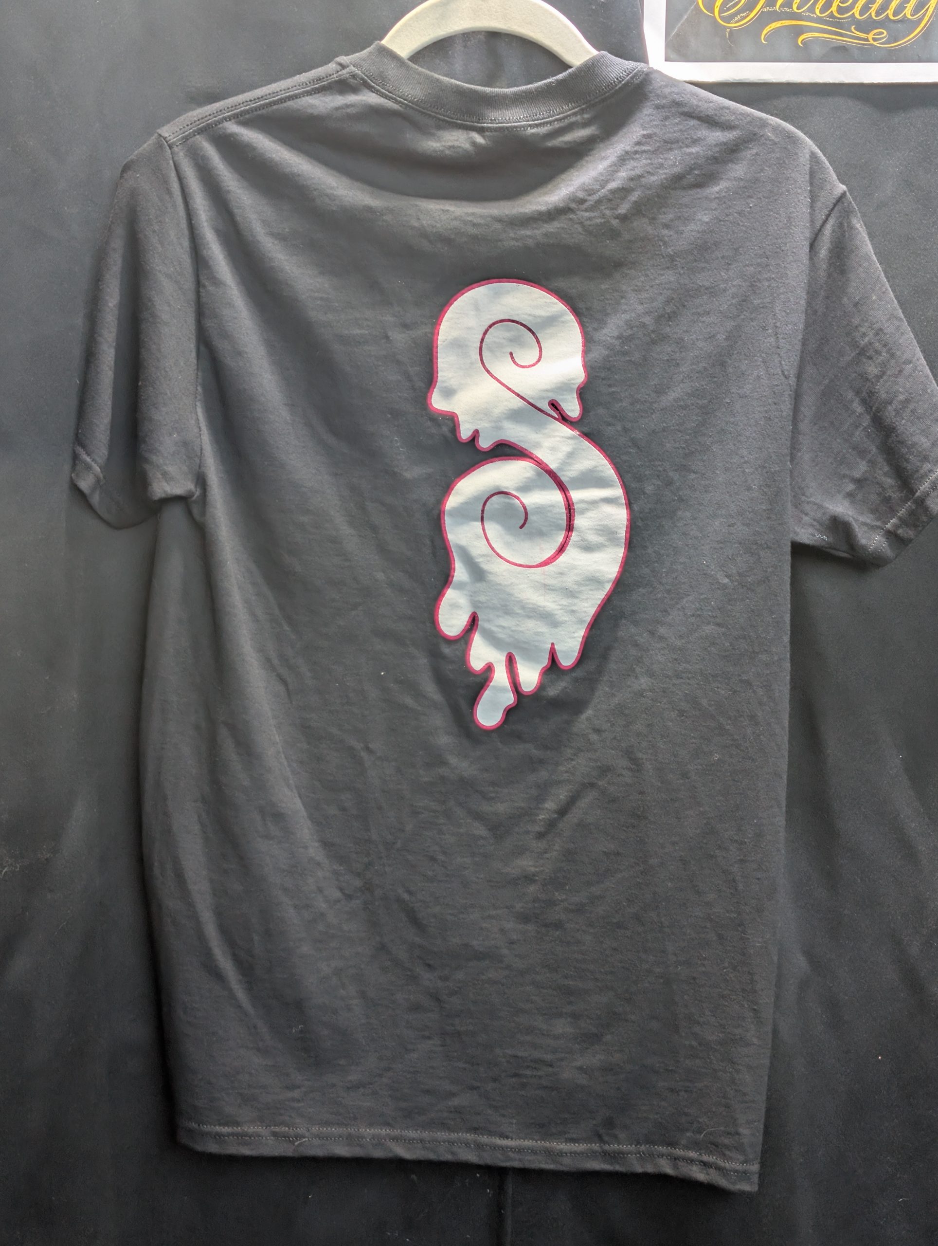 Black shirt featuring hot pink Sticky Canna logo.