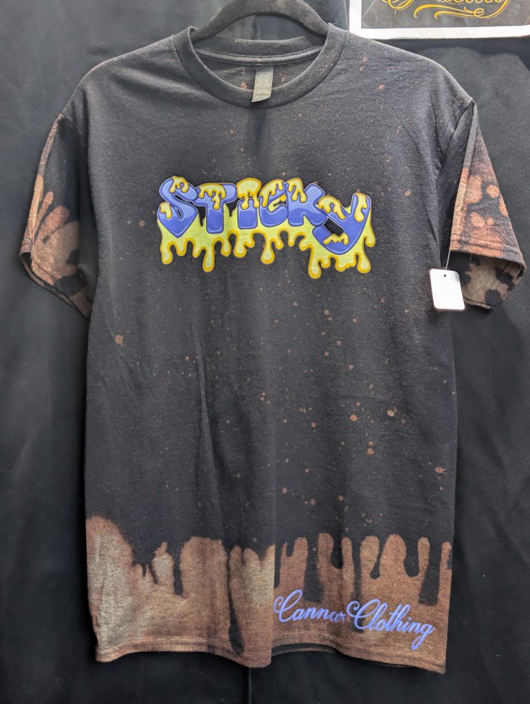 Black bleach washed shirt featuring blue Sticky logo.