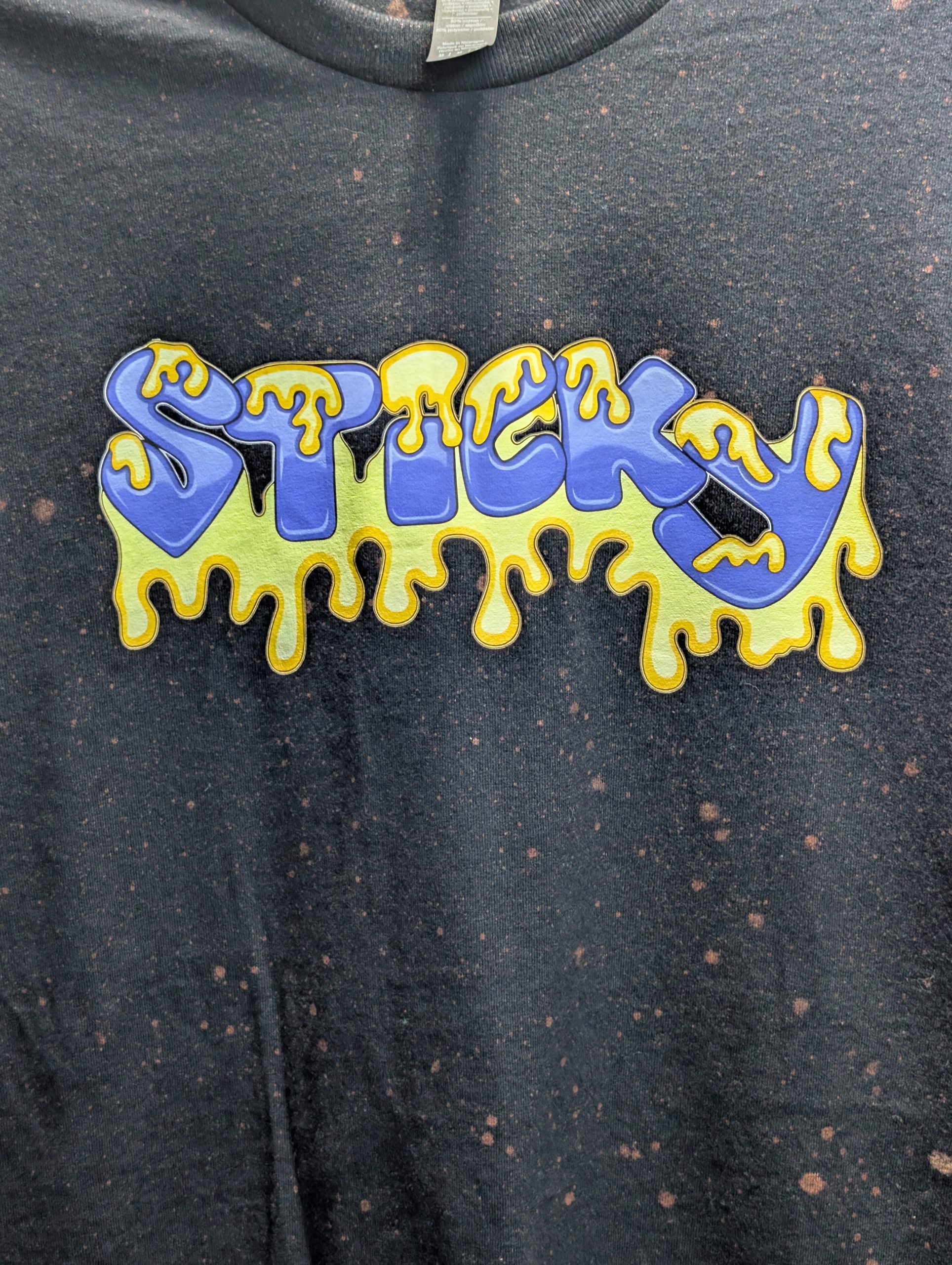 Black bleach washed shirt featuring blue Sticky logo.