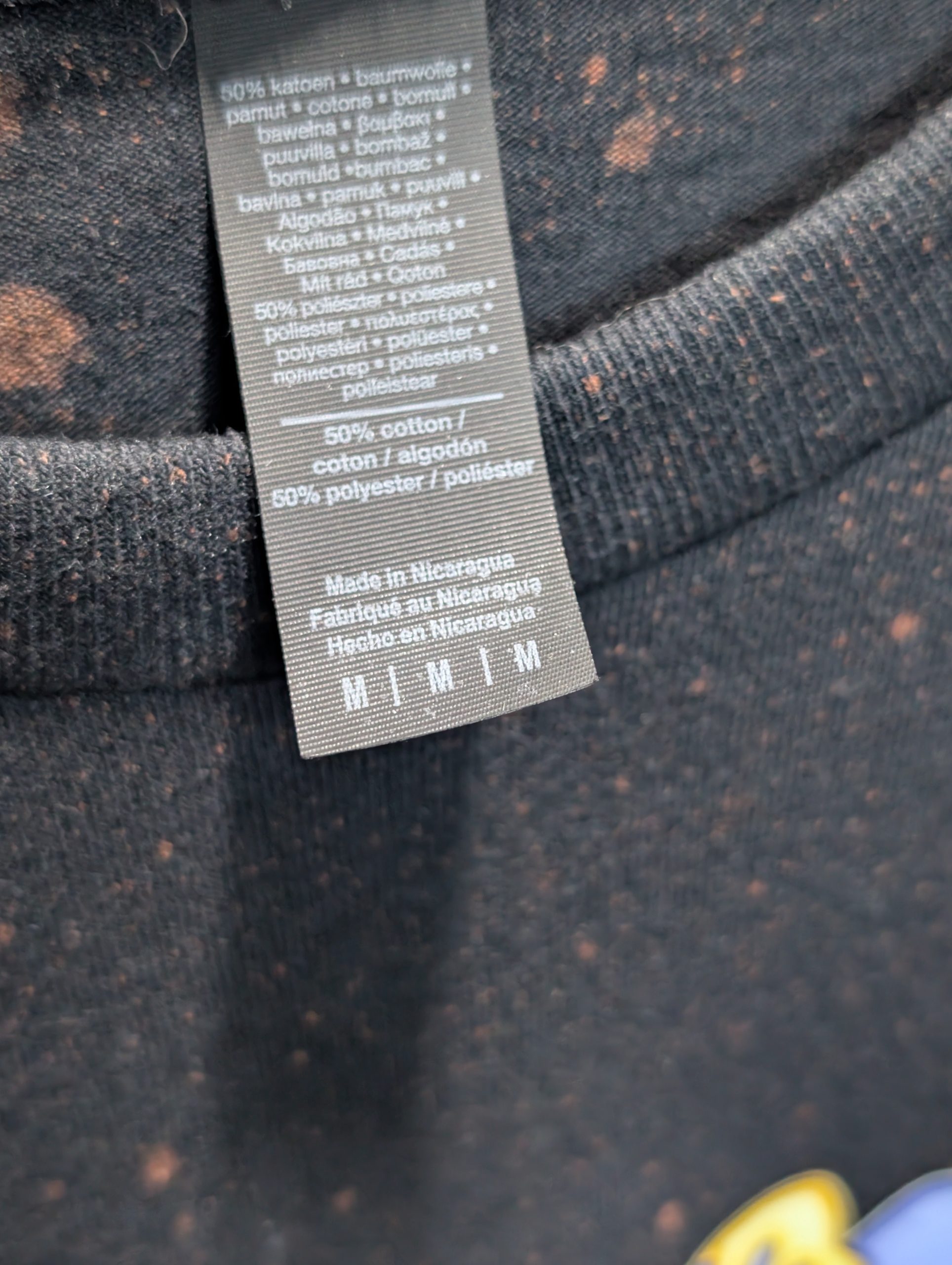 Black bleach washed shirt featuring blue Sticky logo Tag.