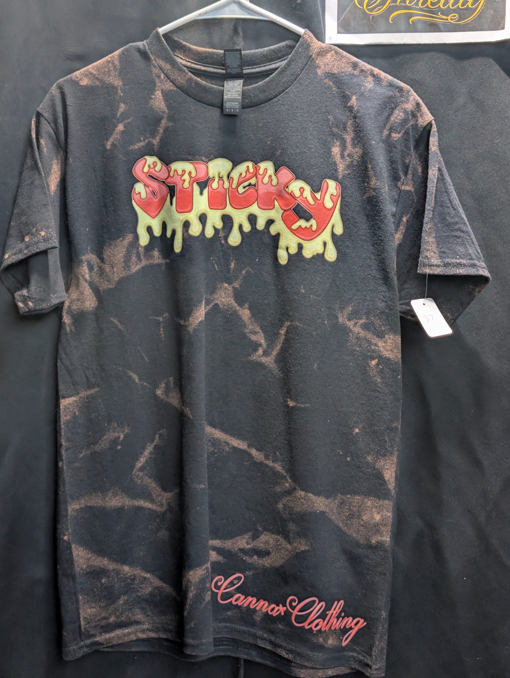 Black bleach washed shirt featuring red Sticky logo.