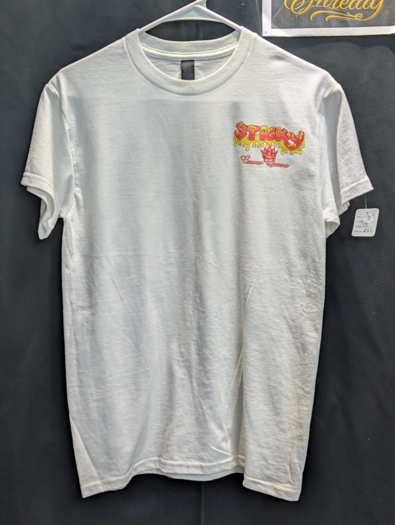White shirt featuring red yellow Sticky Queens logo.