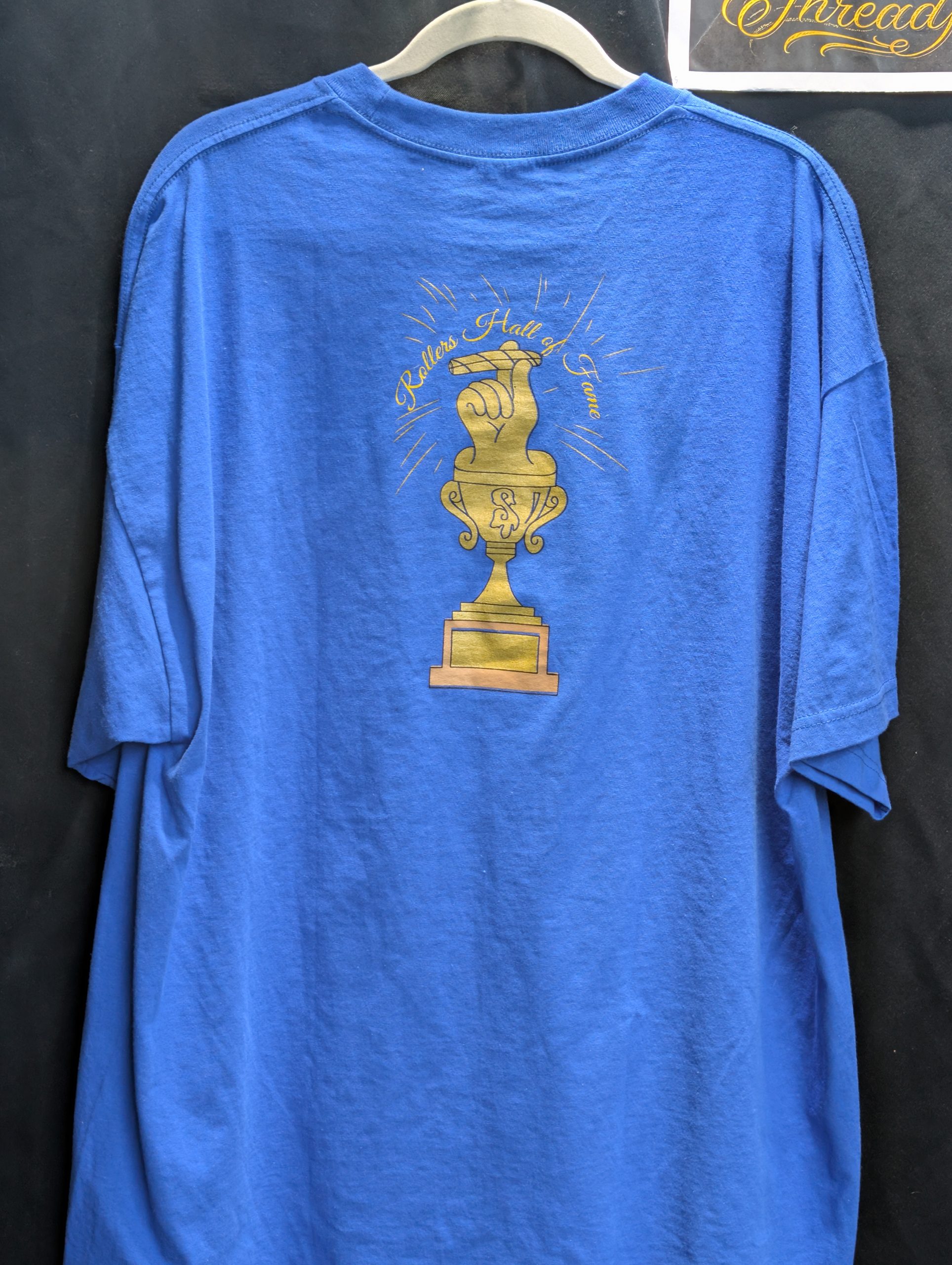 Blue shirt featuring gold Rollers Hall of Fame.