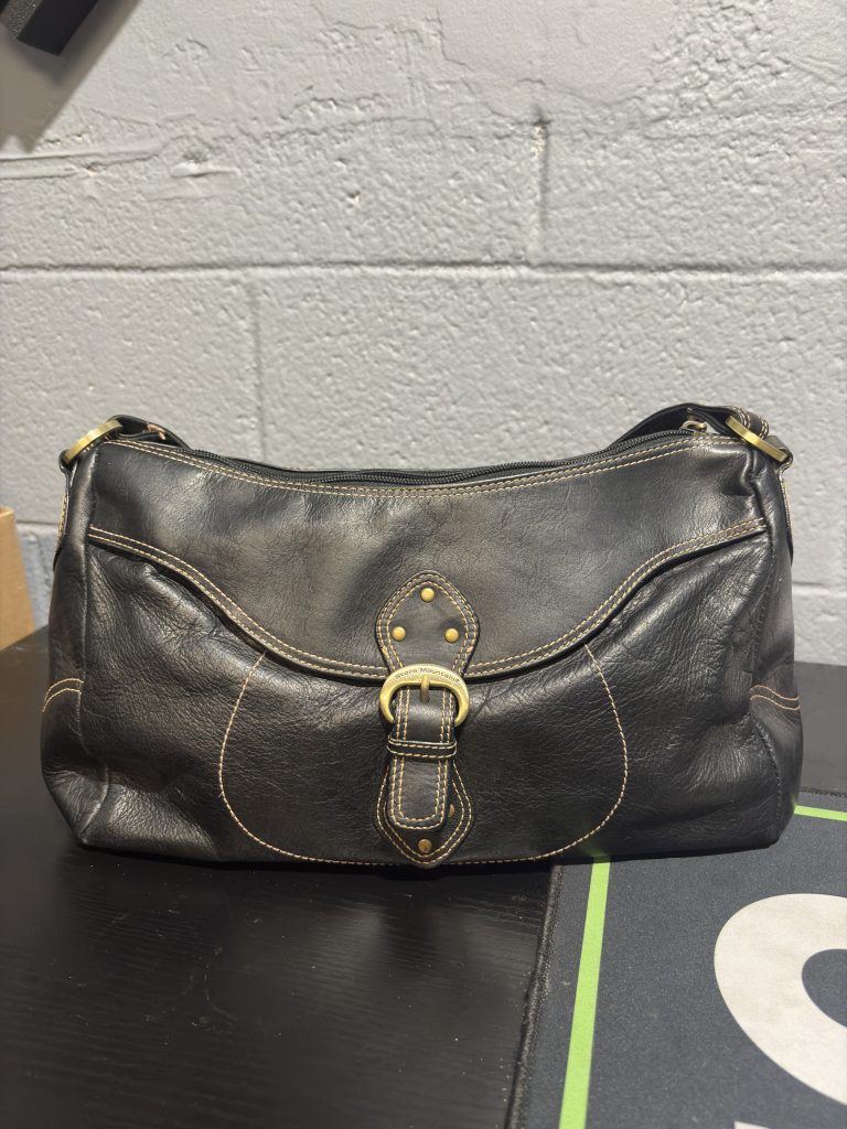 Vintage black leather Stone Mountain shoulder bag with contrast stitching and gold buckle detail