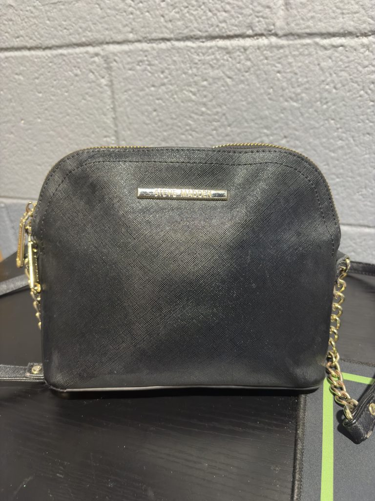 Steve Madden black crossbody bag with gold-tone chain strap and logo hardware, a high-frequency accessory for your inventory.