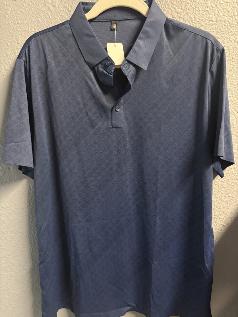 Deep blue performance polo shirt with a subtle geometric embossed texture and three-button collar.