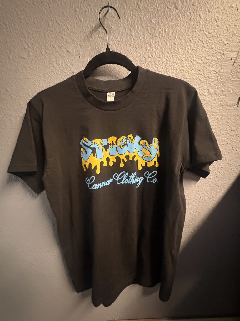 Black graphic t-shirt with "Sticky" logo on front and "Make Original Genetics Great Again" slogan on back.