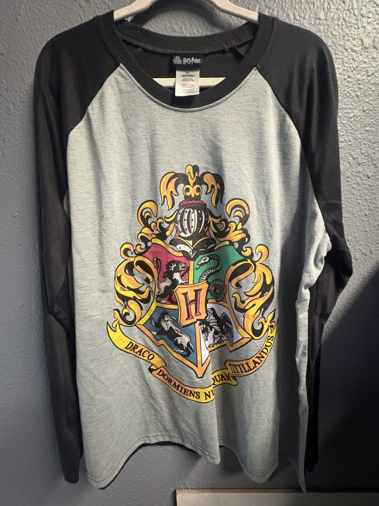 Harry Potter Hogwarts crest raglan long-sleeve shirt with grey body and black sleeves.
