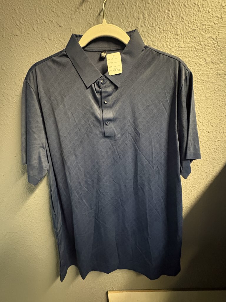 Blue performance polo shirt with geometric embossed texture, three-button collar.