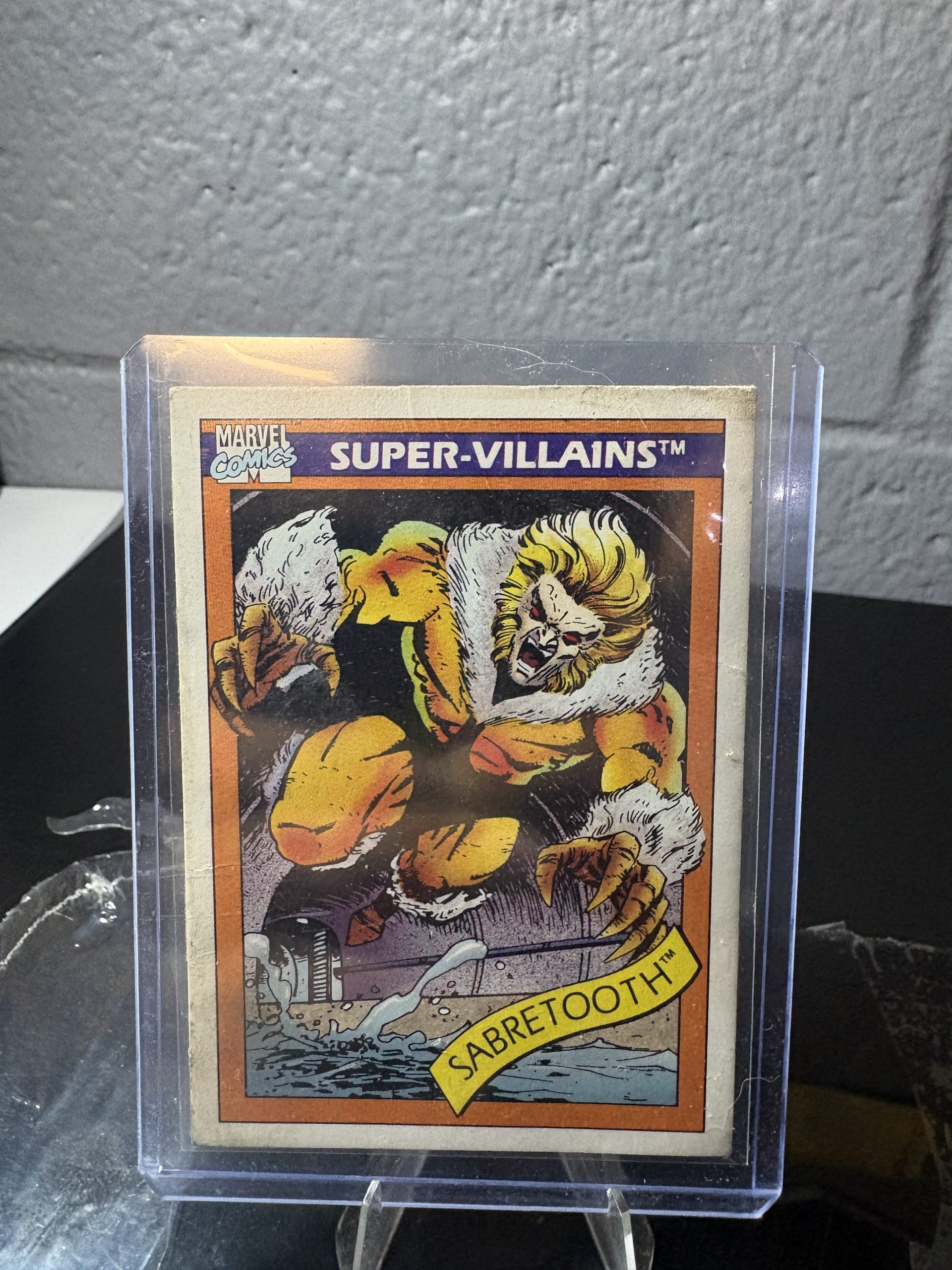 1990 Marvel Universe Sabretooth trading card #57, Super-Villains series, featuring comic art in a protective case.