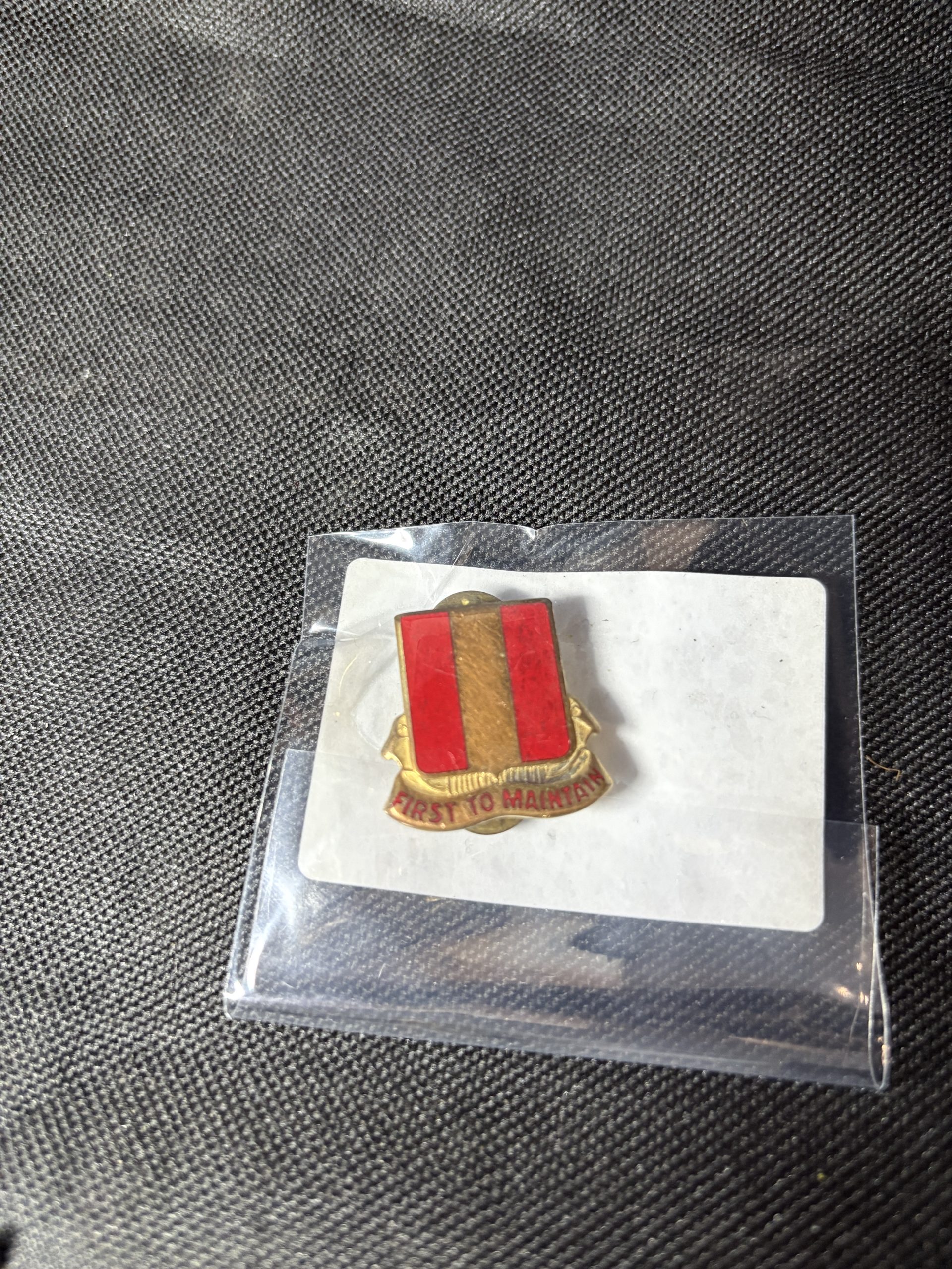 Vintage 39th Ordnance Battalion "FIRST TO MAINTAIN" Distinctive Unit Insignia (DUI) in a protective sleeve.