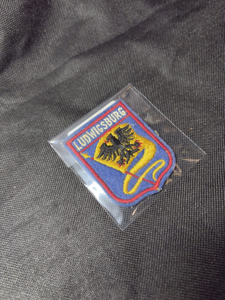 Vintage embroidered Ludwigsburg city crest patch with eagle heraldry design in a protective sleeve.