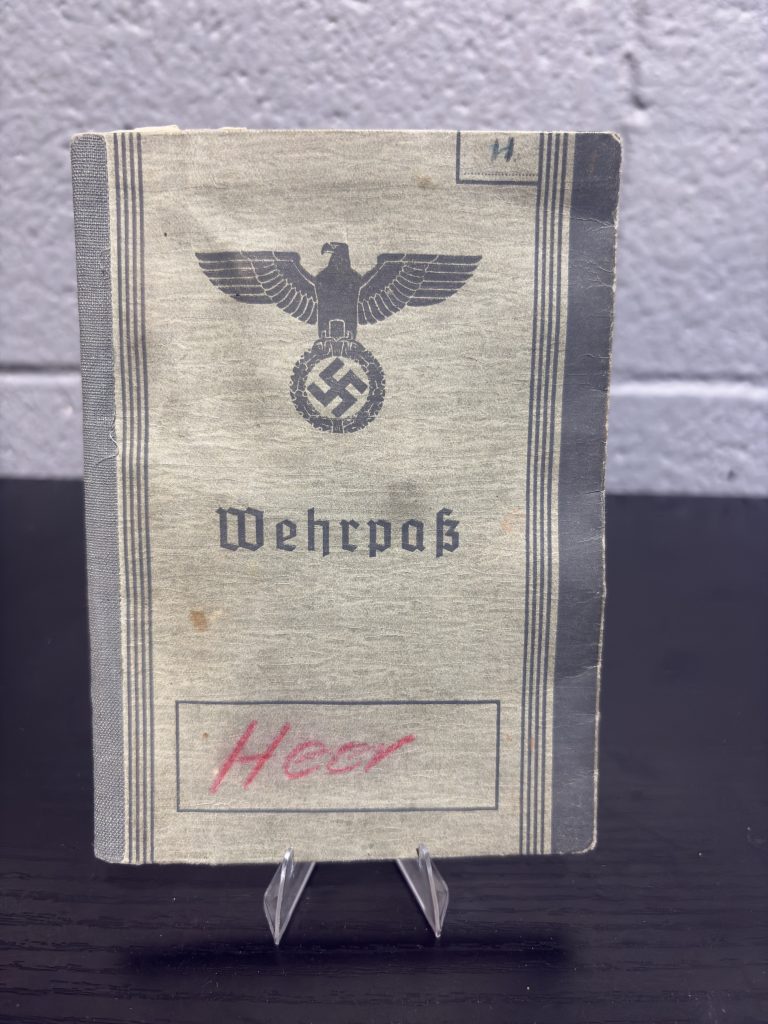 Original WWII German Army Wehrpass document open showing owner photo and personal details.
