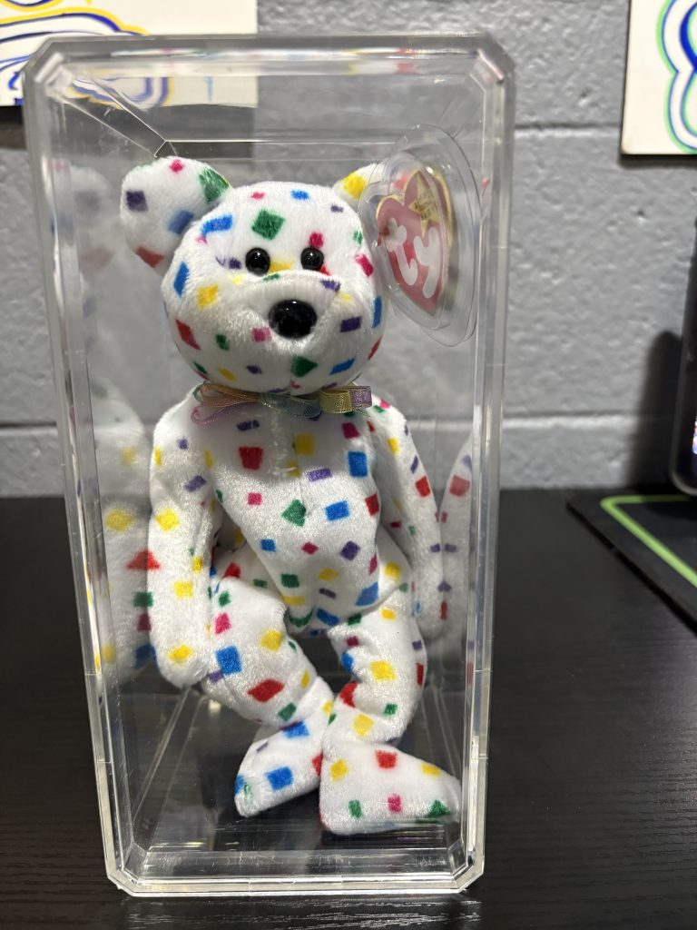 Ty Beanie Baby Ty 2K confetti bear with heart tag in a clear display case.