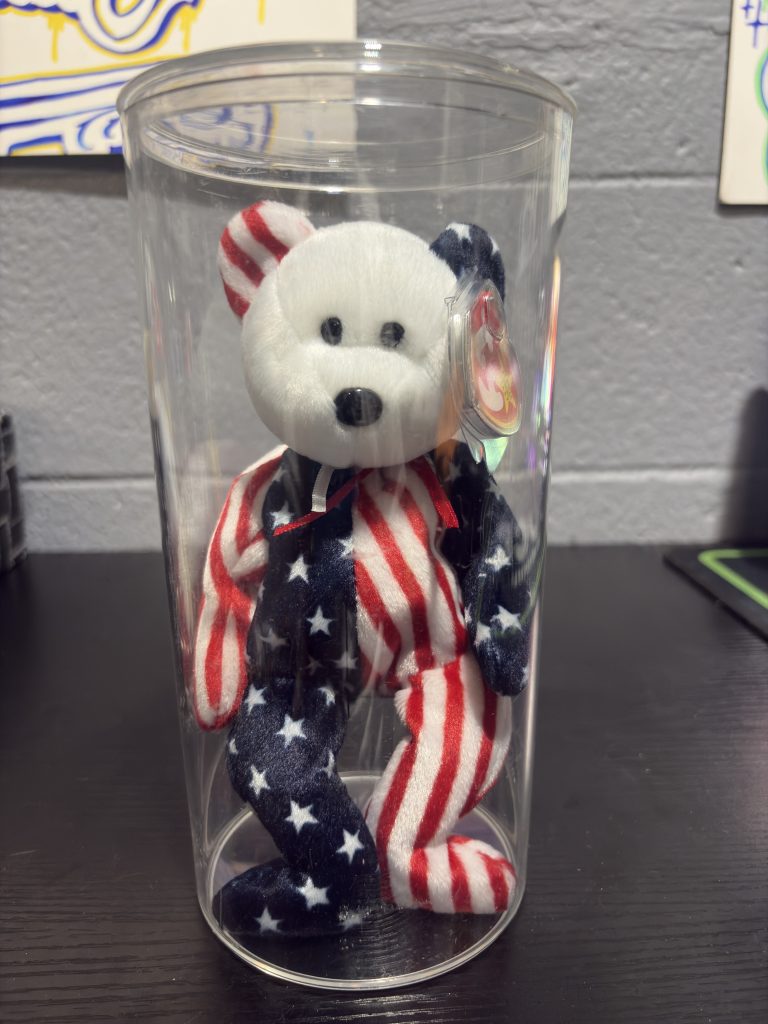 Ty Beanie Baby Spangle patriotic star and stripes bear with heart tag in a clear display cylinder.