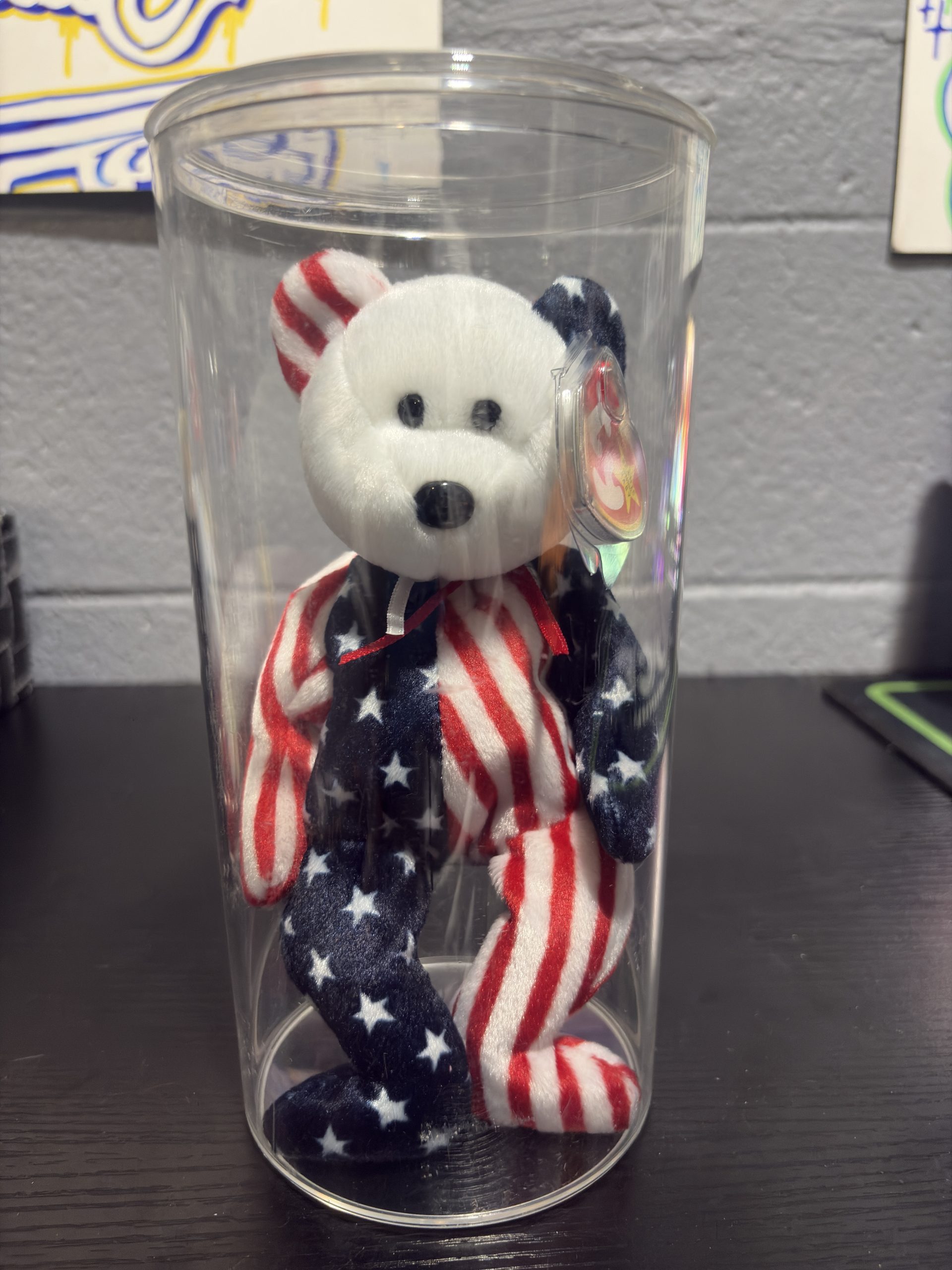 Ty Beanie Baby Spangle patriotic star and stripes bear with heart tag in a clear display cylinder.
