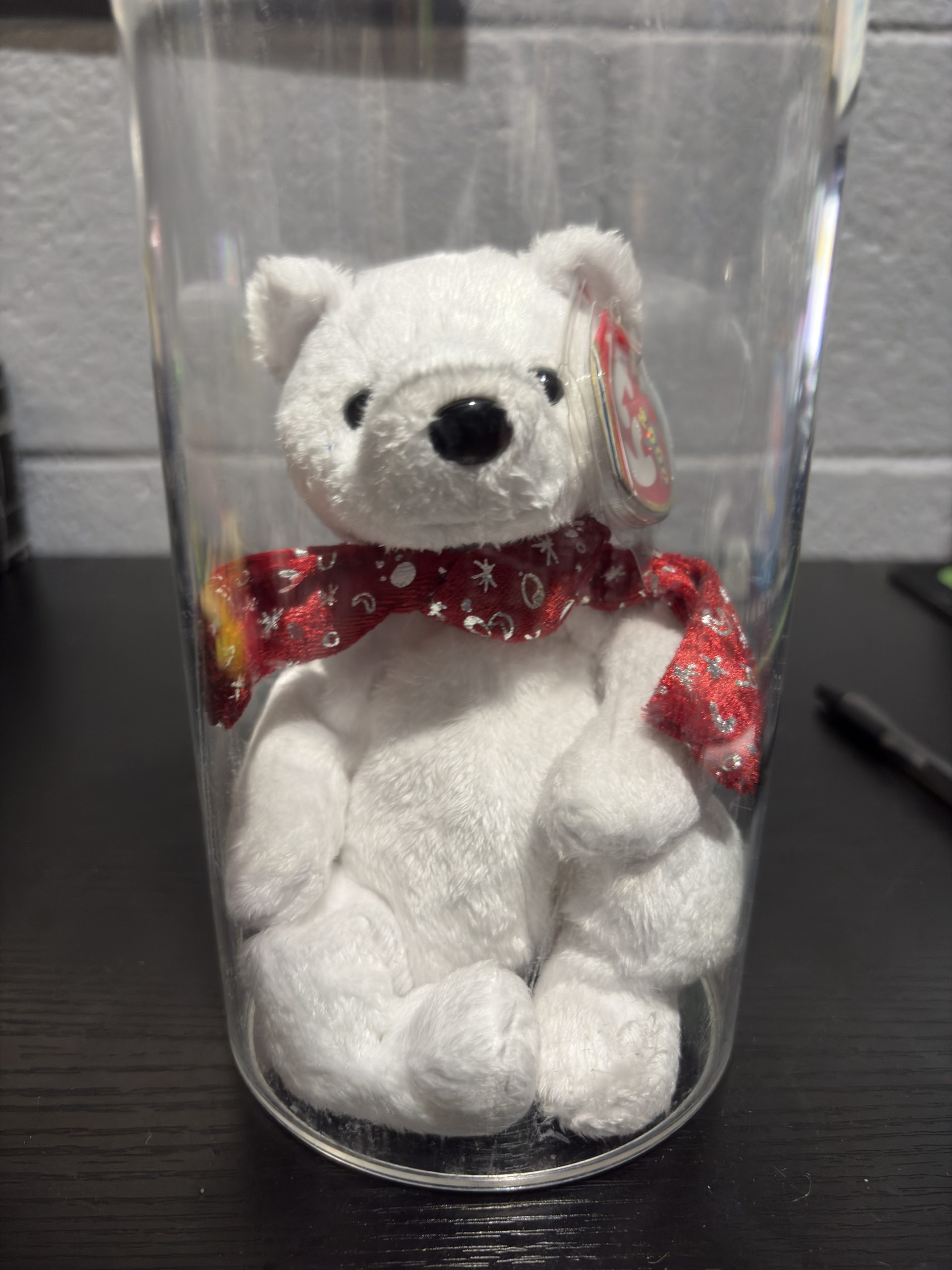 Ty Beanie Baby Holiday Teddy white bear with red metallic scarf in a clear display cylinder.