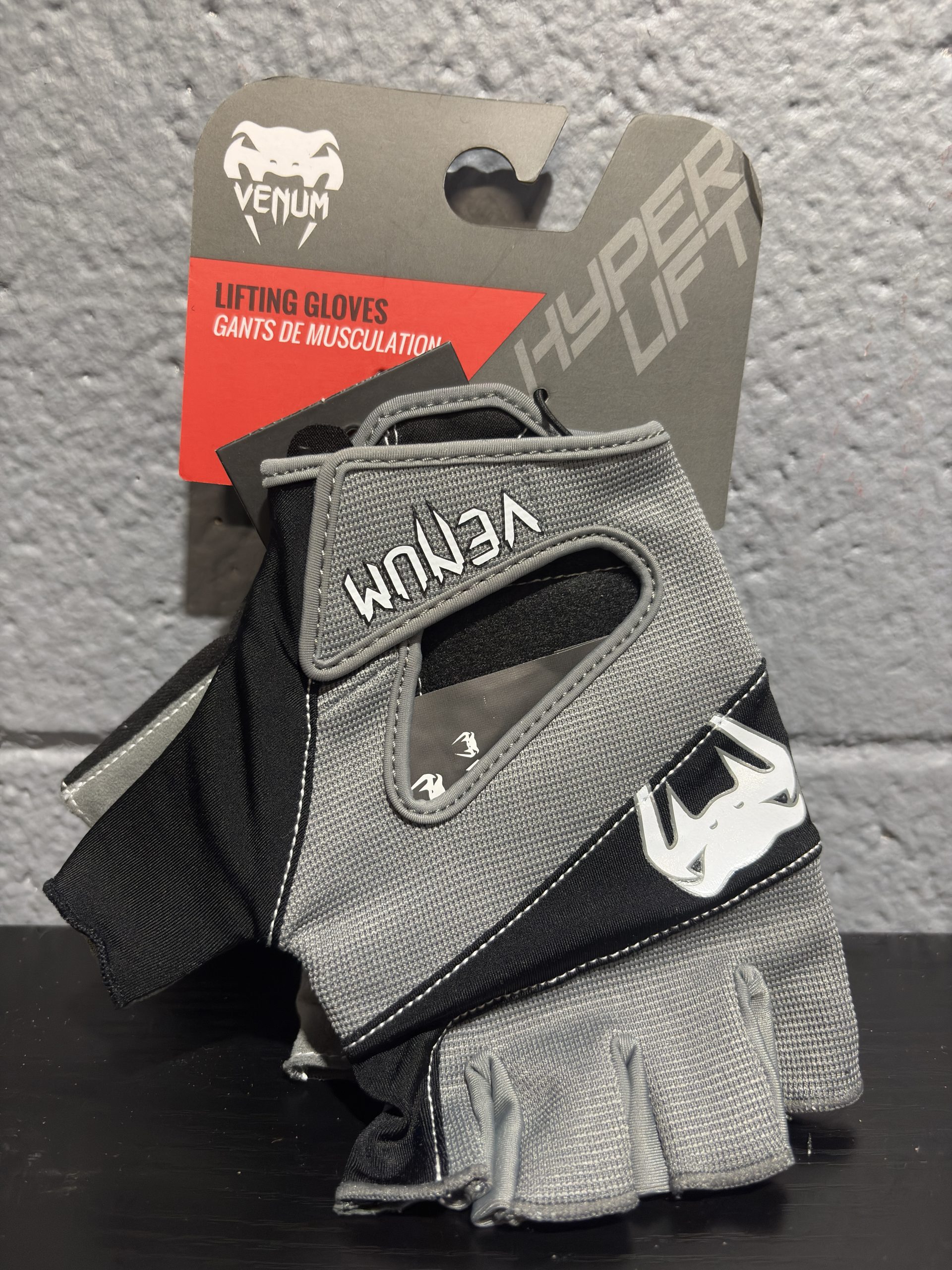 Venum Hyperlift Lifting Gloves in Grey and Black displayed with their brand tag.