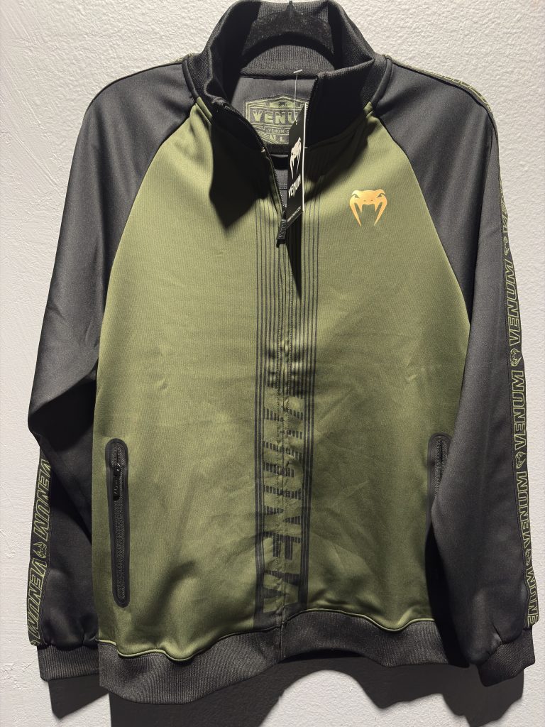 Venum Full-Zip Track Jacket in Khaki and Black showing the front zipper, chest logo, and size tag.