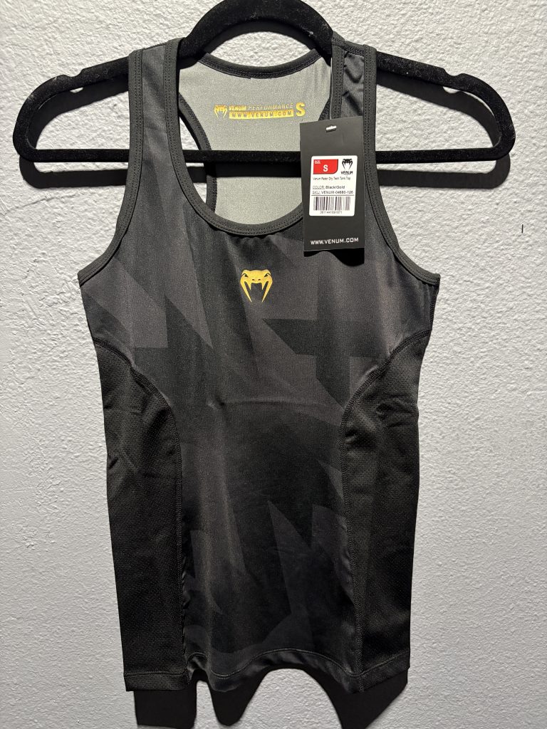 Venum Razor Dry Tech Tank Top in Black and Gold showing the chest logo, tag, and racerback collar in size S.