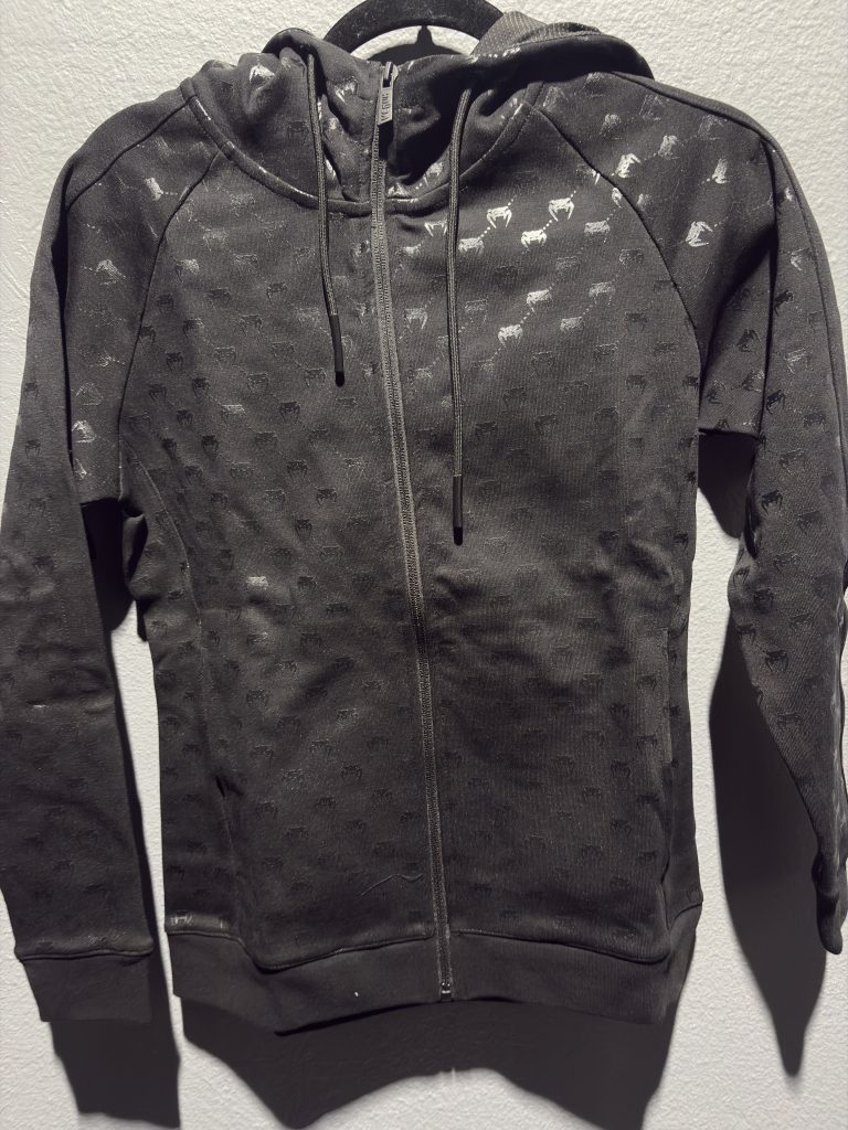 Venum Laser Monogram Women's Full-Zip Hoodie in Black and Pink Gold showing the full zip and brand tag in size S.