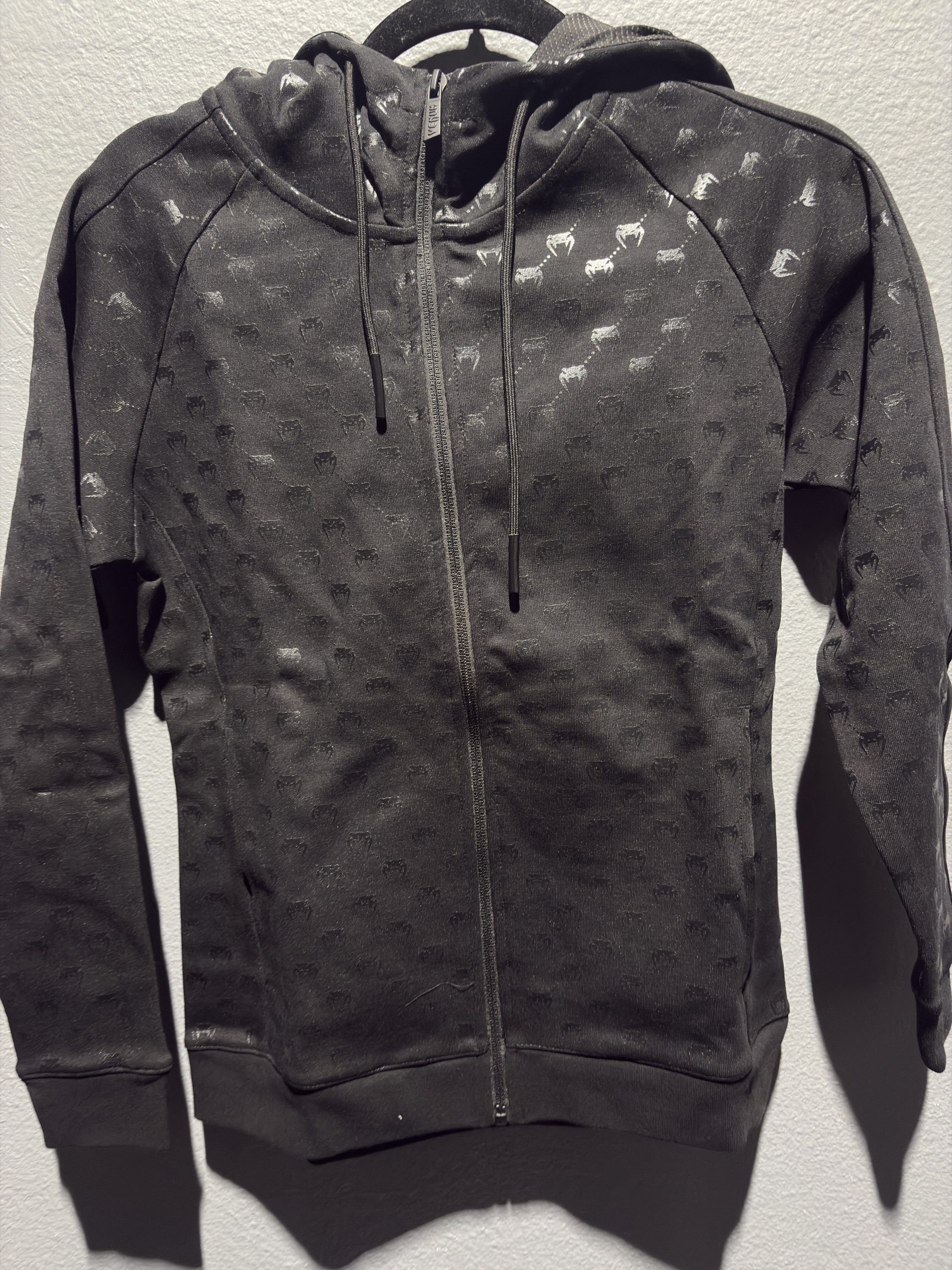 Venum Laser Monogram Women's Full-Zip Hoodie in Black and Pink Gold showing the full zip and brand tag in size S.