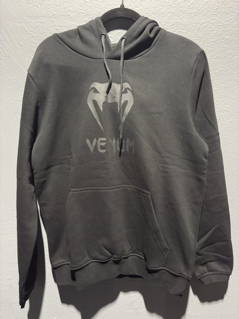 Venum Classic Hoodie in Black/Black showing the chest logo and retail tag in size M.