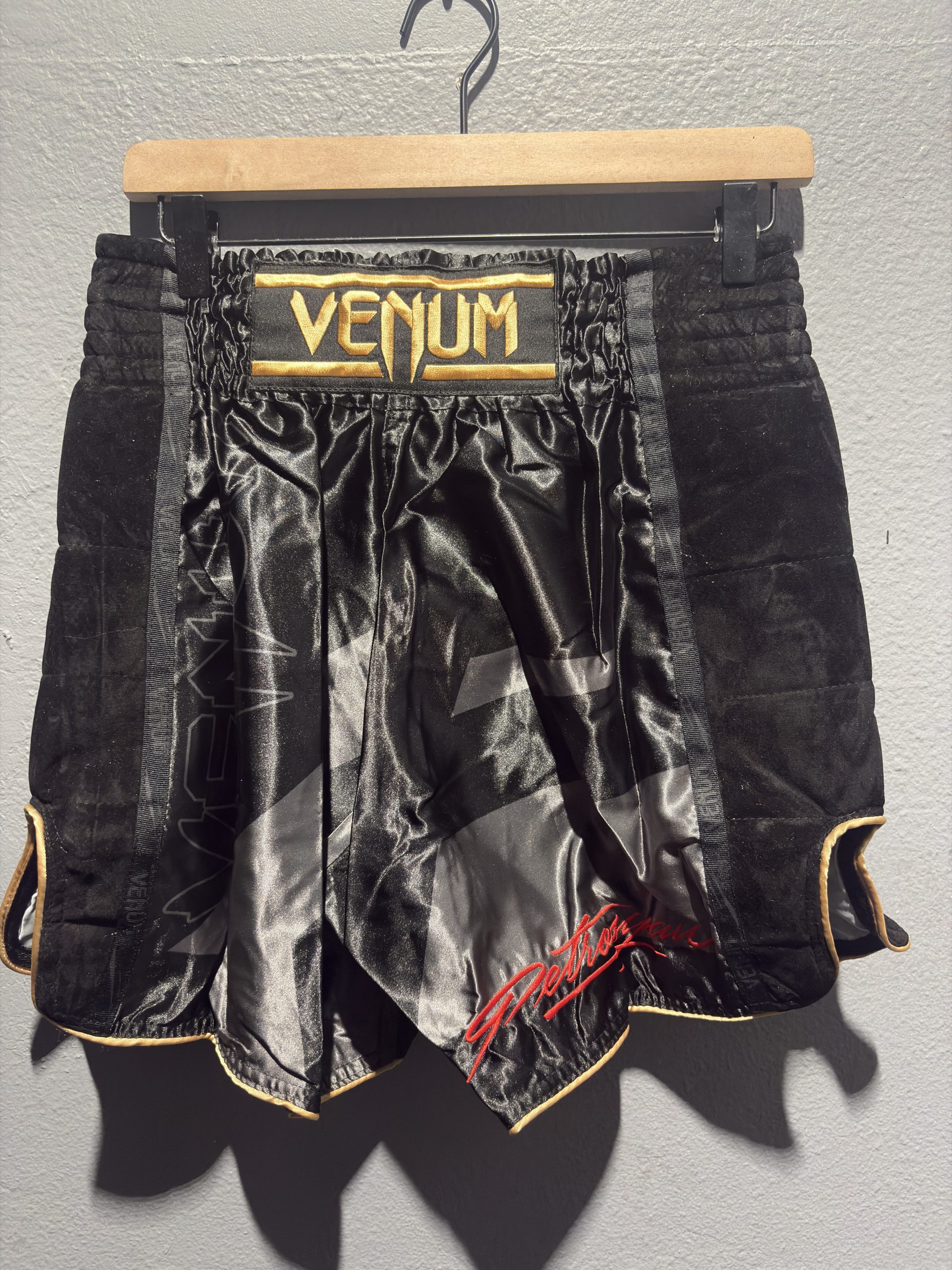 Venum Petrosyan 2.0 Muay Thai Shorts in Black and Gold showing the gold waistband patch and retail tag in size XXL.