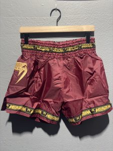Venum Parachute Muay Thai Shorts in Burgundy showing the elastic waistband, brand tag, and side logo in size XL.