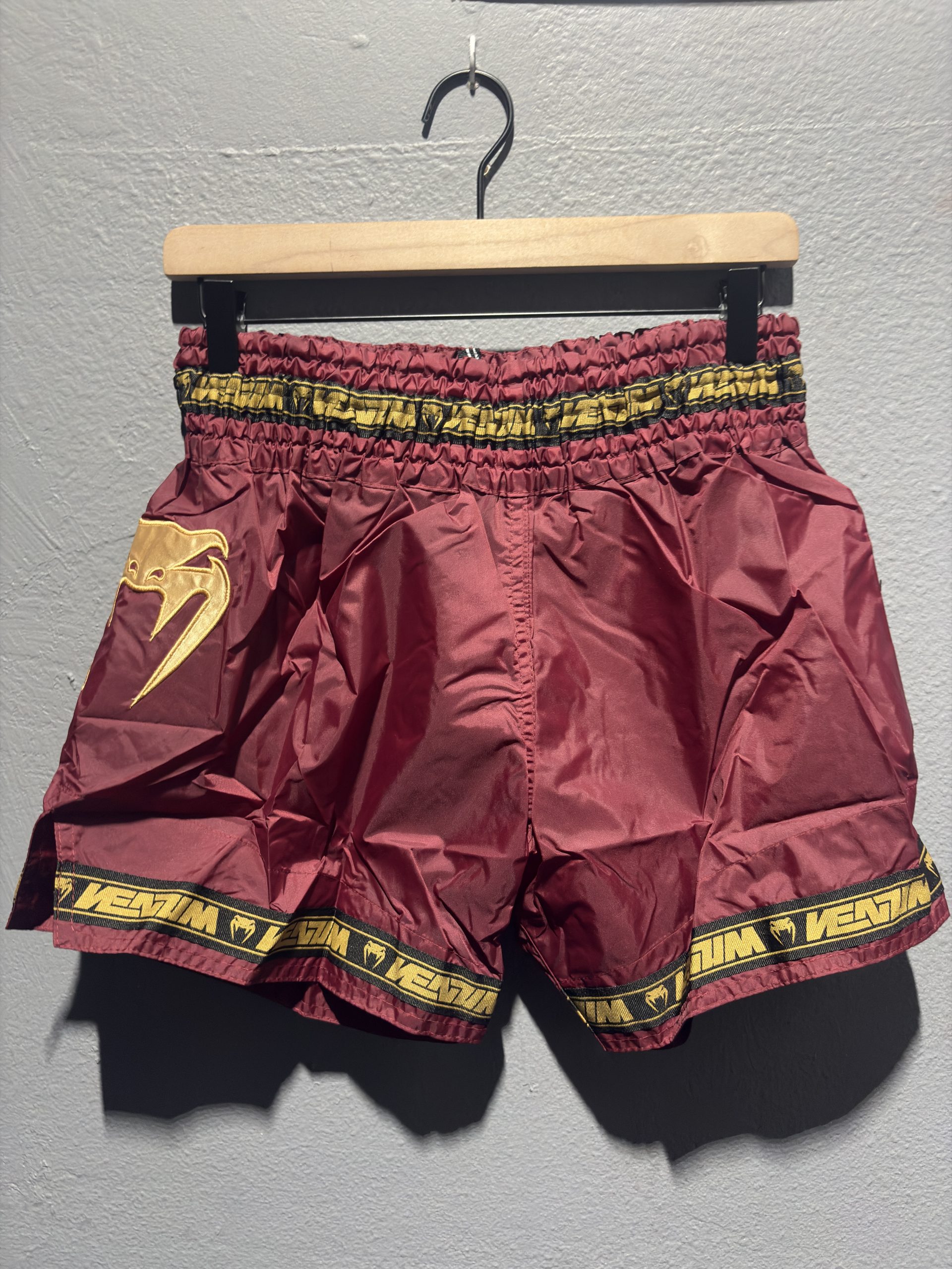 Venum Parachute Muay Thai Shorts in Burgundy showing the elastic waistband, brand tag, and side logo in size XL.