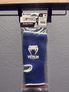 Venum Kontact Ankle Guard in Blue inside original clear packaging showing the header card and "Unique" size label.