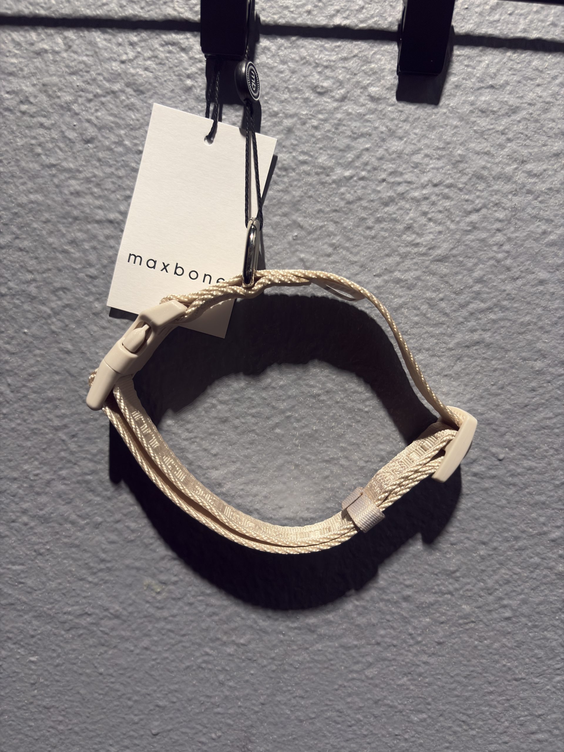 Maxbone designer pet collar in beige featuring repeating brand lettering, a quick-release buckle, and hang tag.