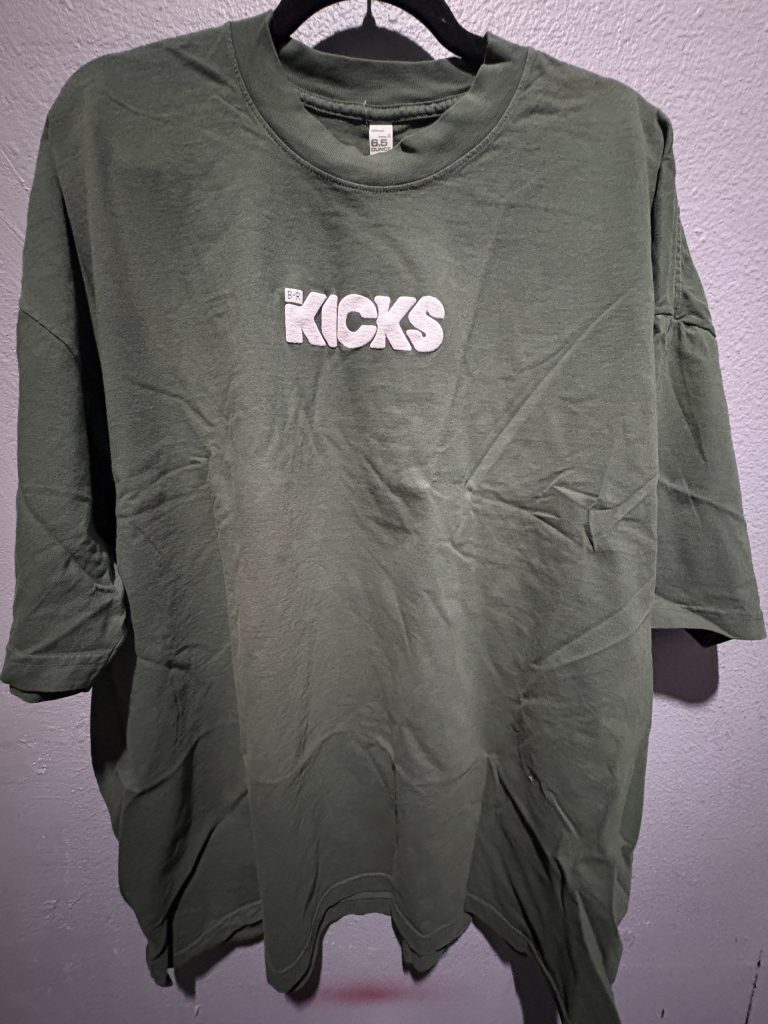 Los Angeles Apparel Bleacher Report KICKS embroidered t-shirt in olive green showing the front chest lettering and size 2XL tag.