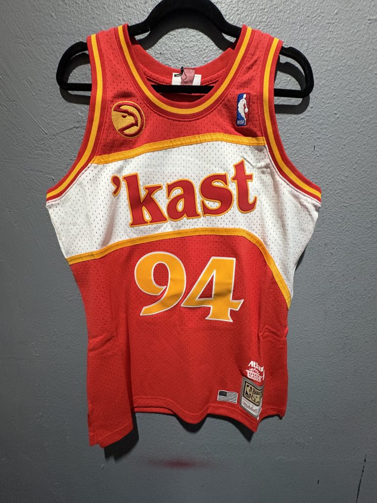 OutKast x Bleacher Report x Mitchell & Ness Atlanta Hawks Remix Jersey in Red showing the front 'kast chest text, number 94, and tags.