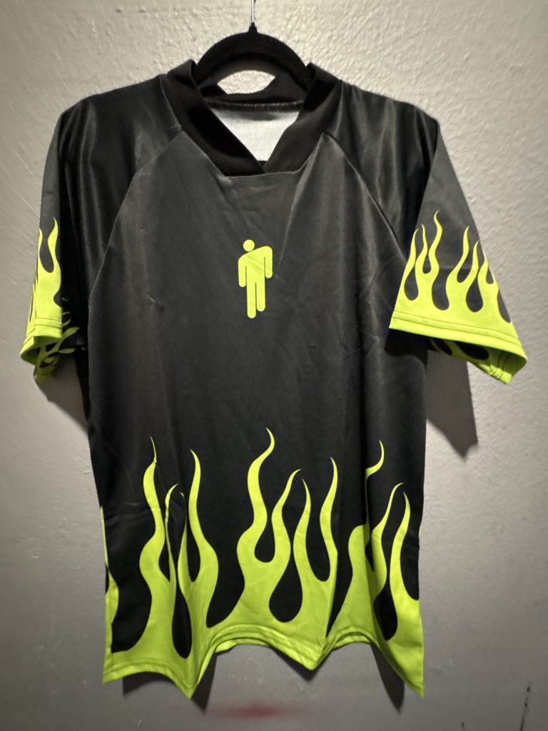 Bleacher Report Billie Eilish flame graphic soccer jersey in black and neon green showing the front blohsh logo and back Eilish 6 text in size L.