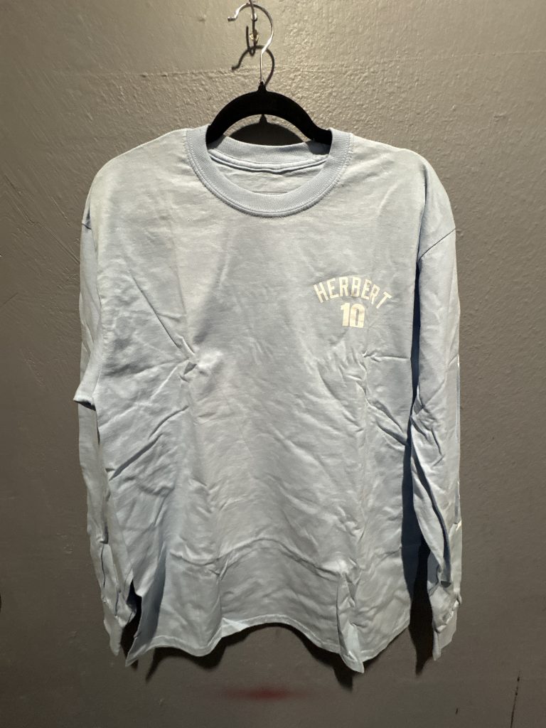 Bleacher Report Justin Herbert Los Angeles Chargers graphic long sleeve t-shirt in powder blue showing the front text, sleeve branding, and back photo graphic in size L.