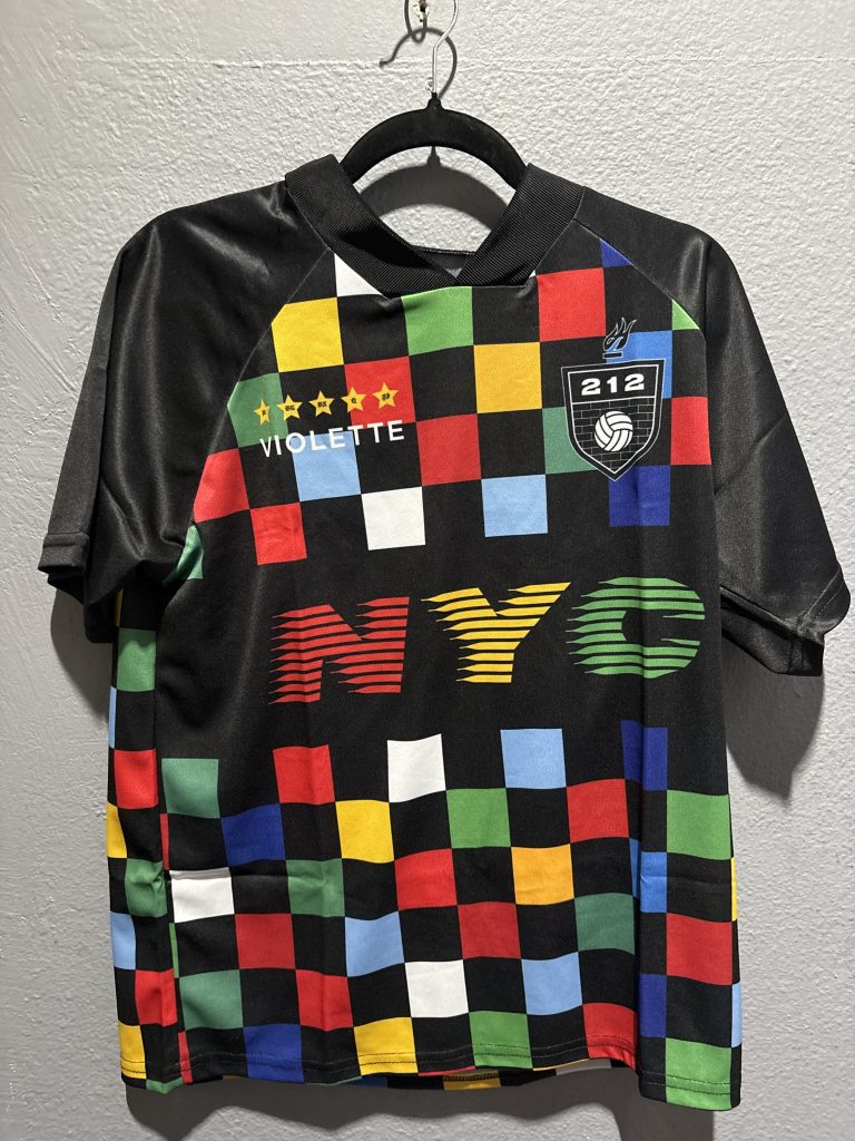 Bleacher Report Violette NYC 212 grid graphic soccer jersey in multi-color block pattern showing the front chest details and size XS tag.